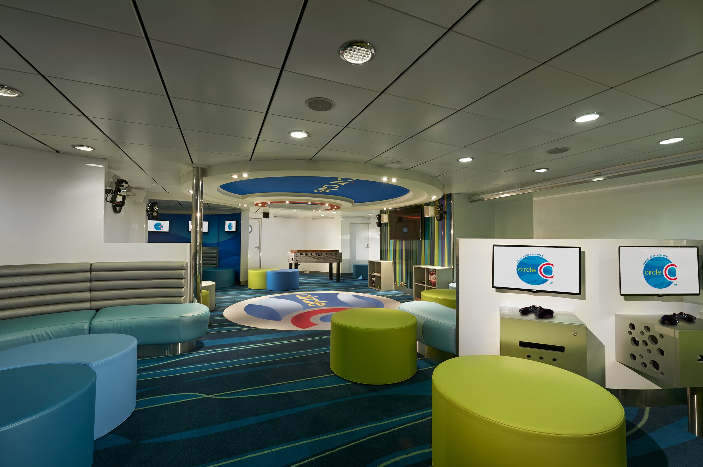 Carnival Sunrise Circle C youth lounge with curved sofas, colourful poufs and game consoles