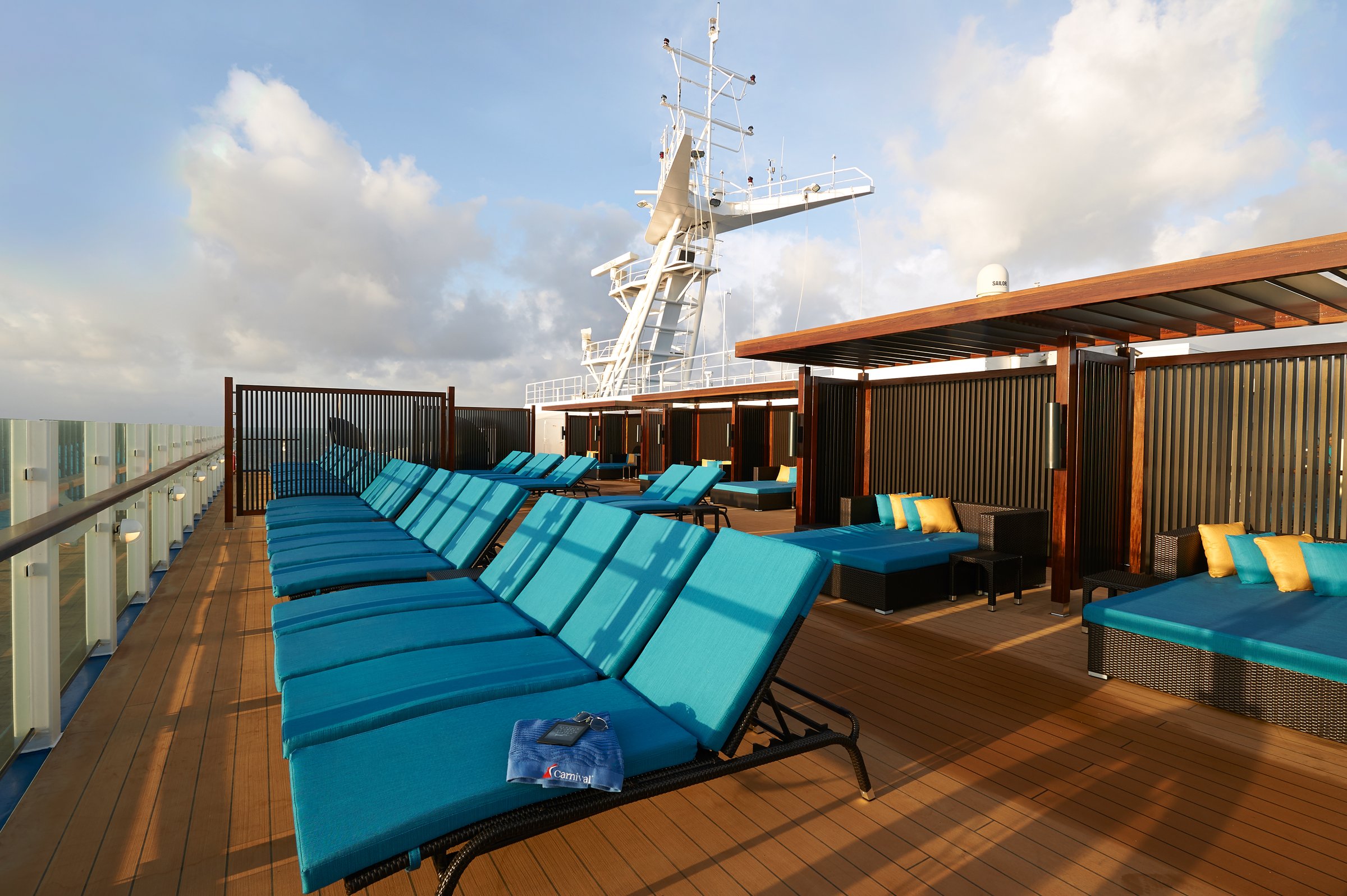 Carnival Sunrise Serenity adults-only deck with teal loungers and shaded cabanas