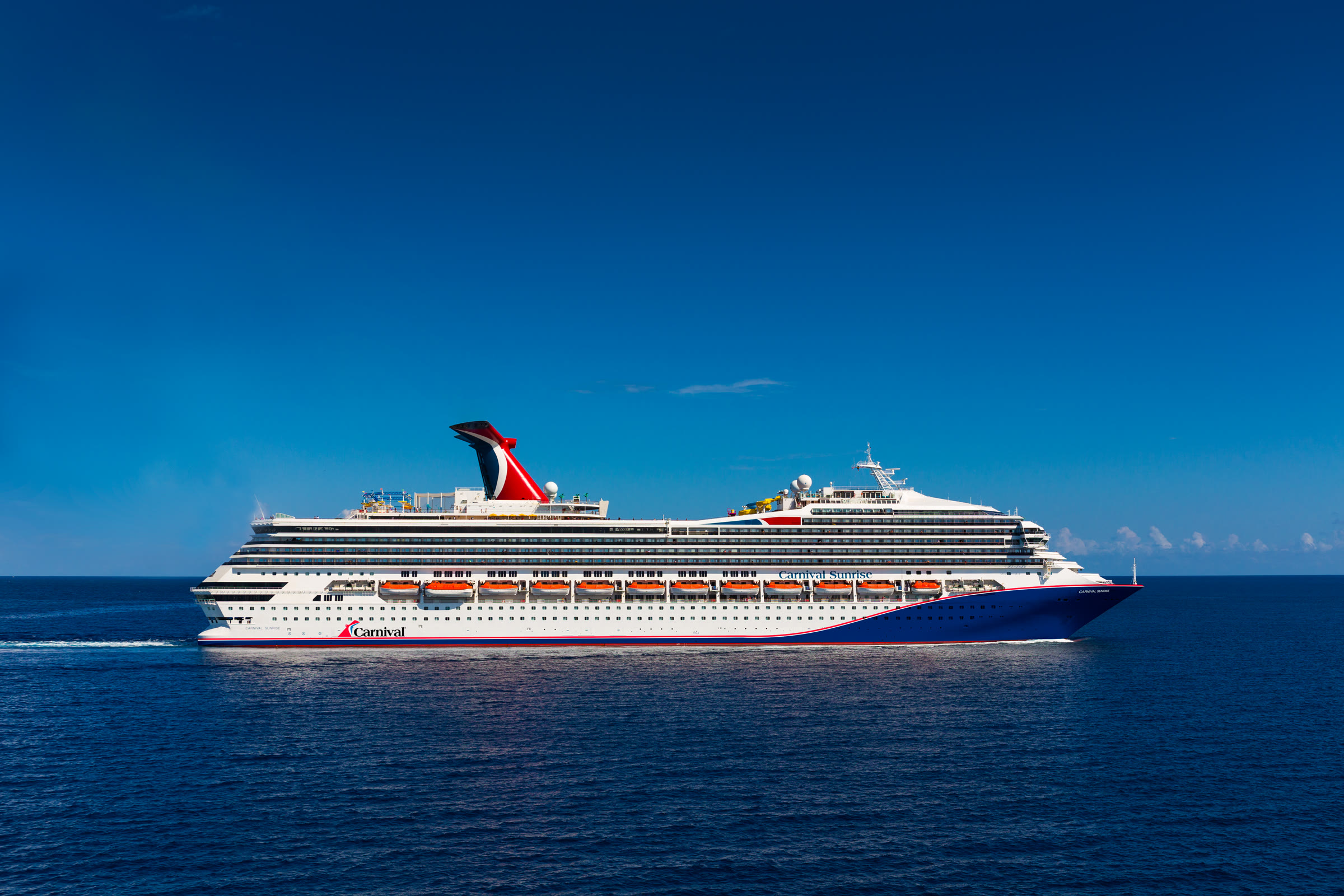 Carnival Sunrise blue-hull exterior at sea, bright sunny daylight