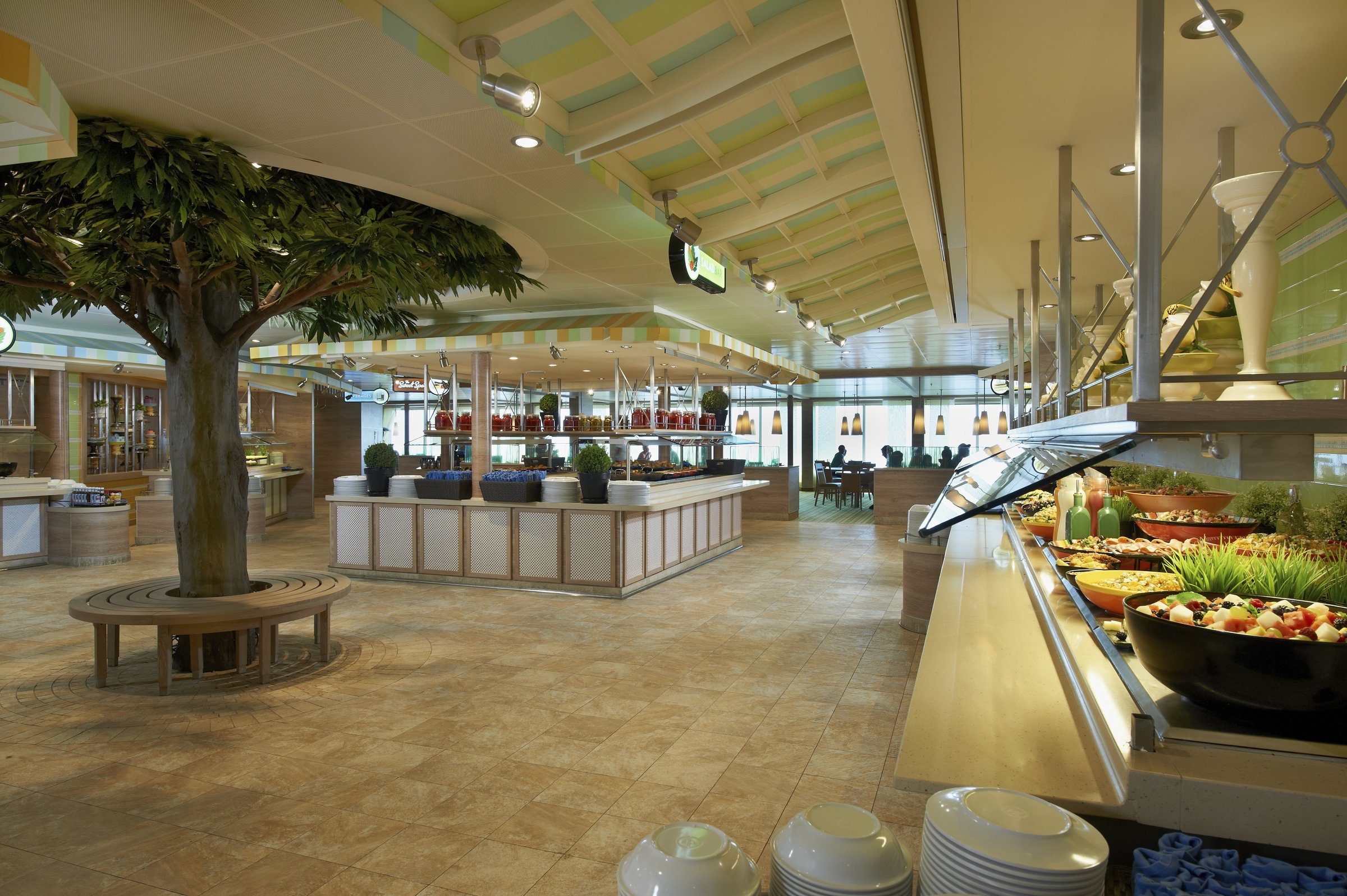 Carnival Sunshine Lido Marketplace buffet with a central tree and a salad bar in the foreground