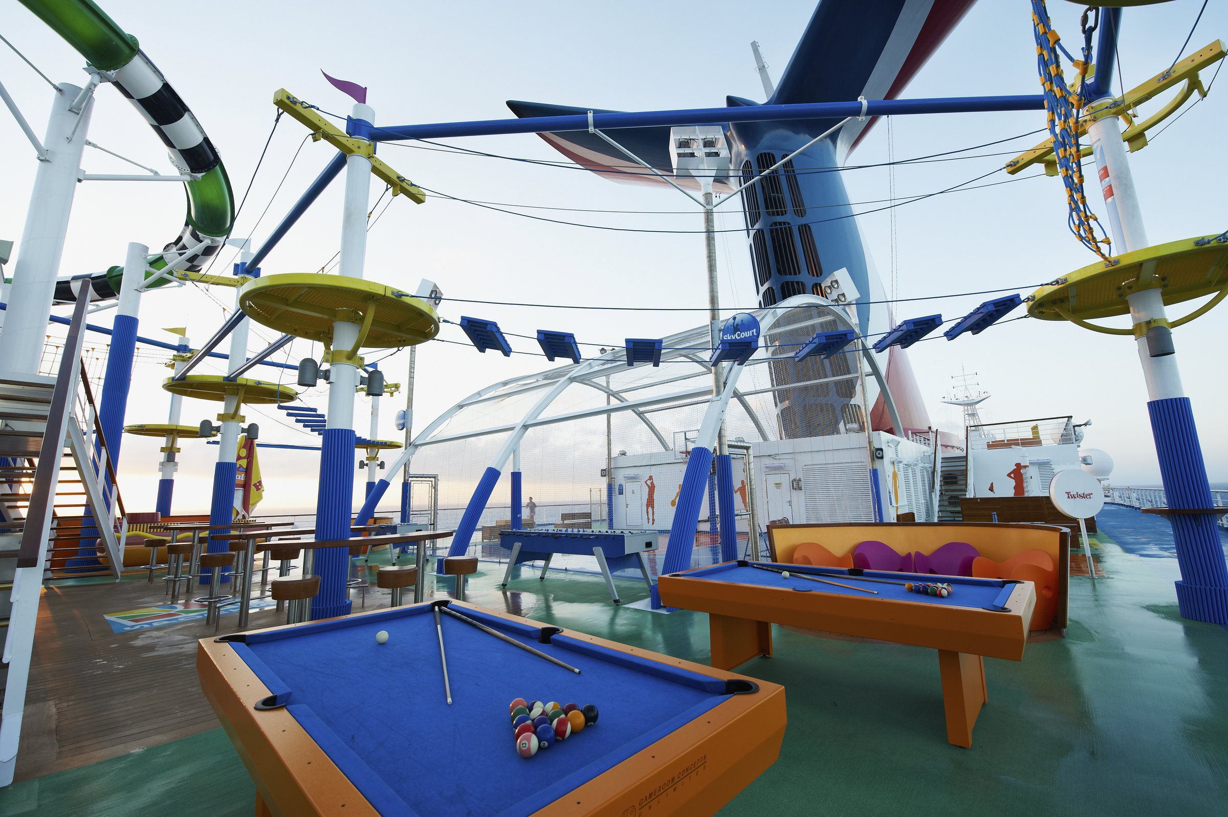 Carnival Sunshine sports deck with pool tables under the ropes course on a clear day