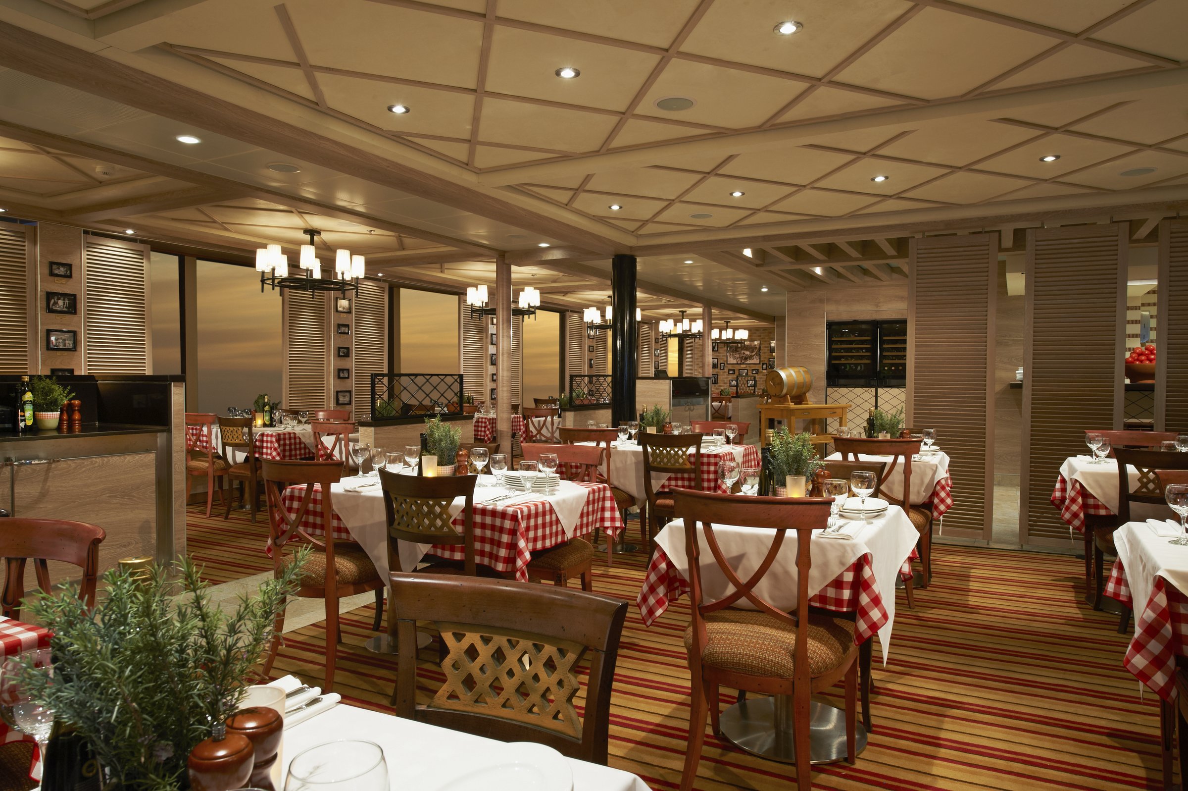 Carnival Sunshine Cucina del Capitano Italian restaurant with checked tablecloths and warm wood details