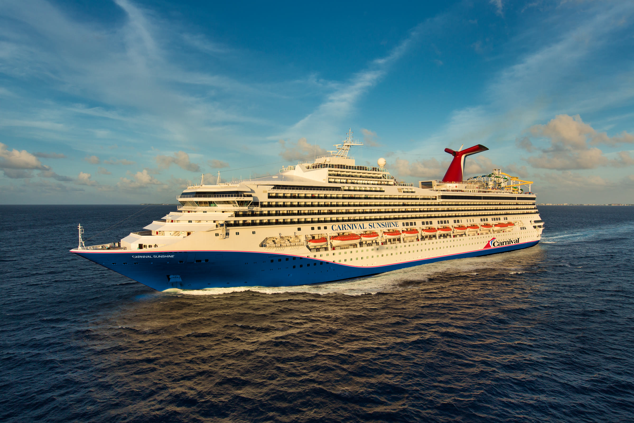 Carnival Sunshine blue-hull exterior at sea, sunny daylight