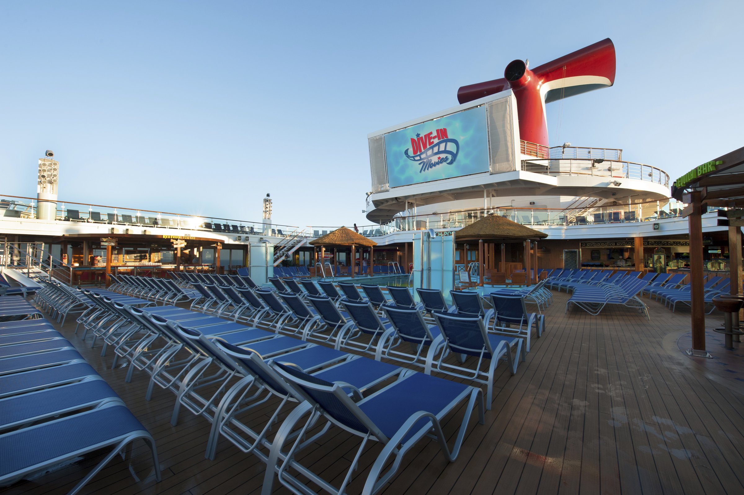 Carnival Sunshine pool deck with rows of loungers and the Dive-In movie screen