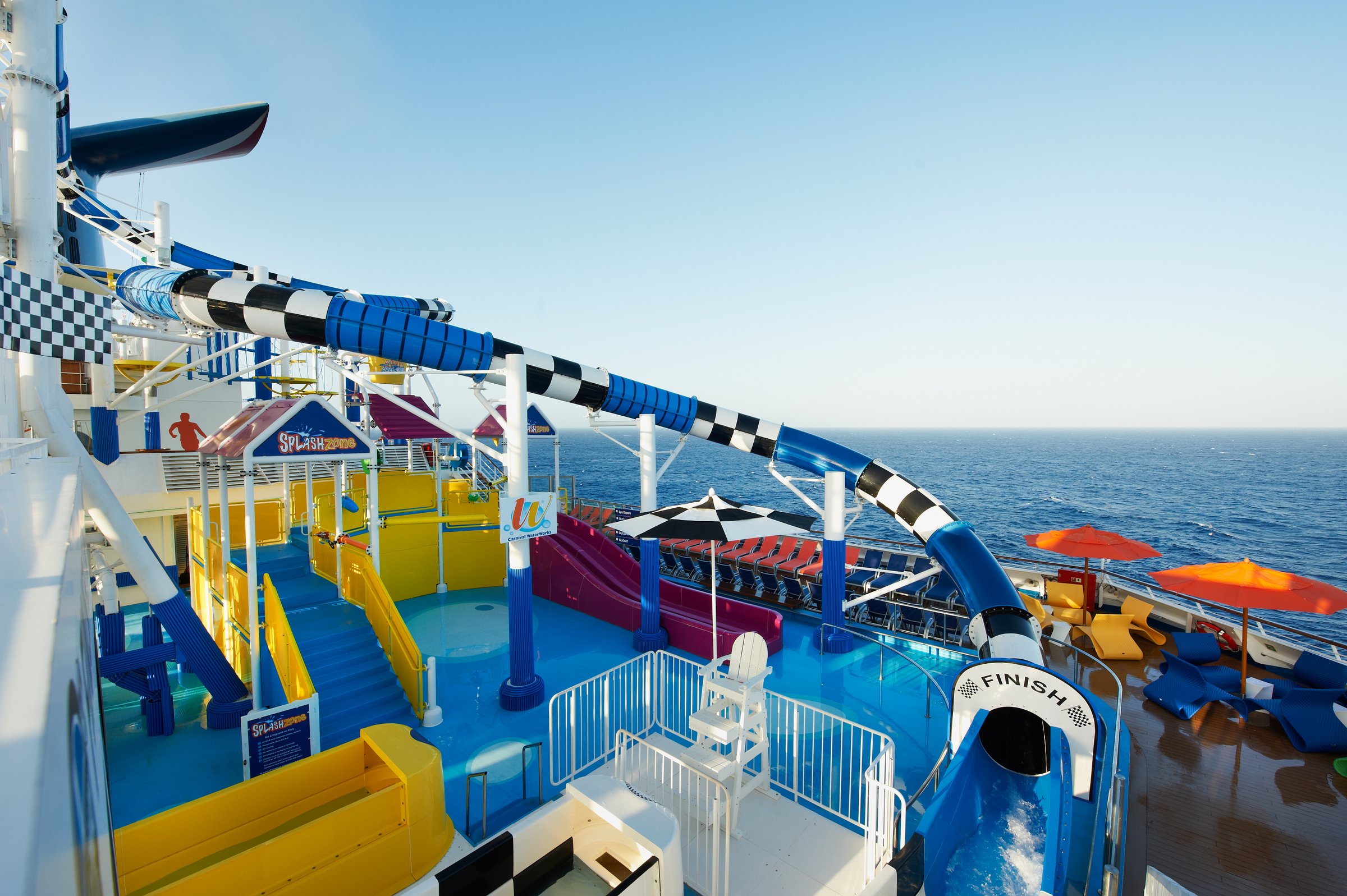 Carnival Sunshine WaterWorks with checkered slides and splash deck against a clear sky