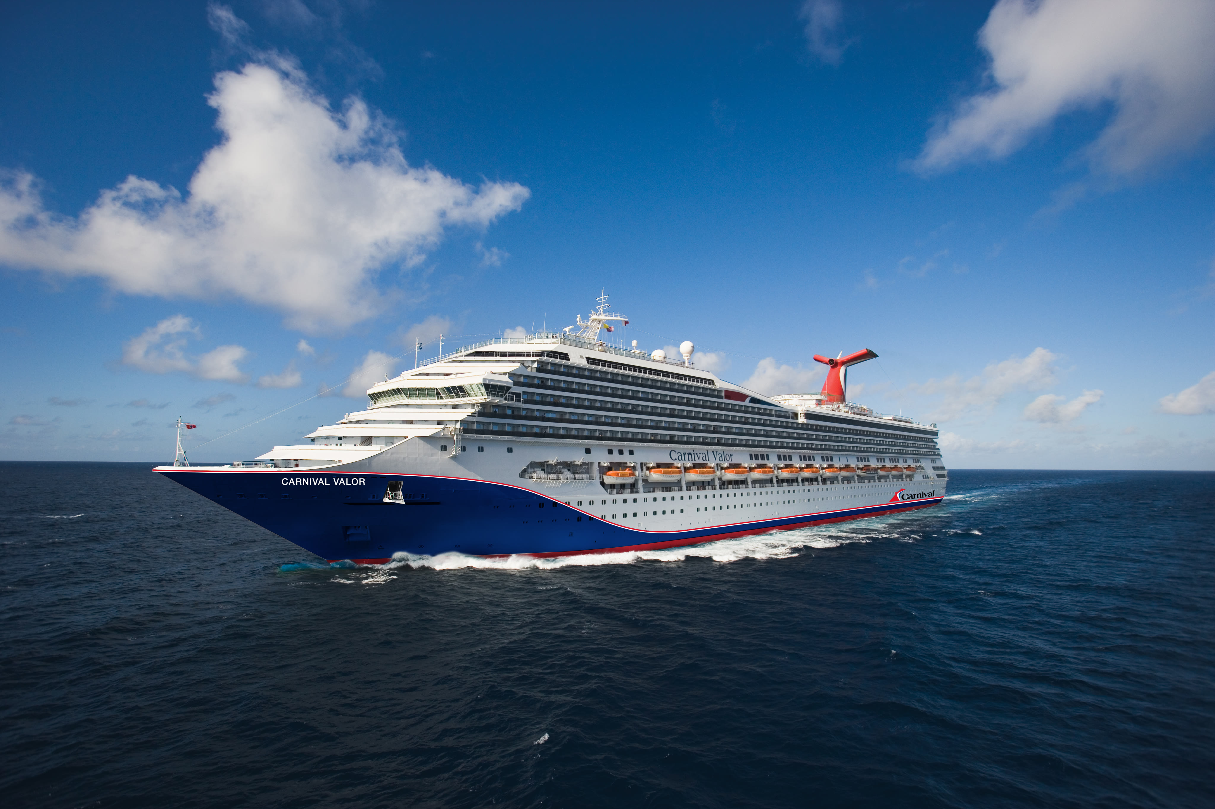 Carnival Valor blue hull aerial at sea under clear sky