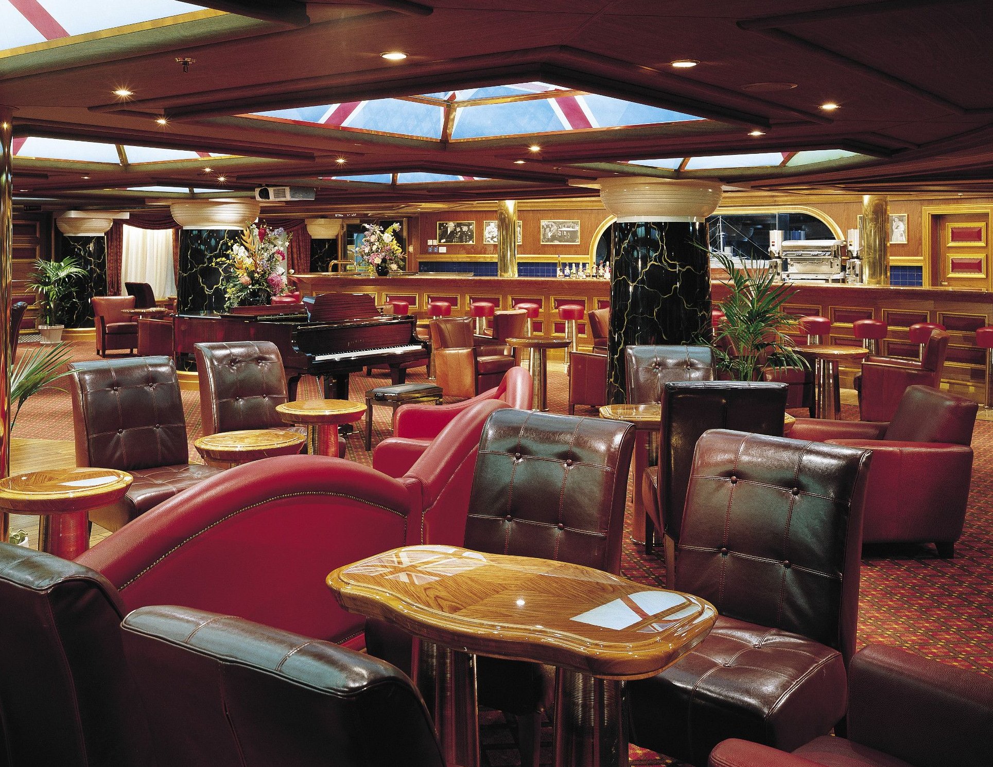 Carnival Valor piano lounge with leather armchairs, skylights and a long bar