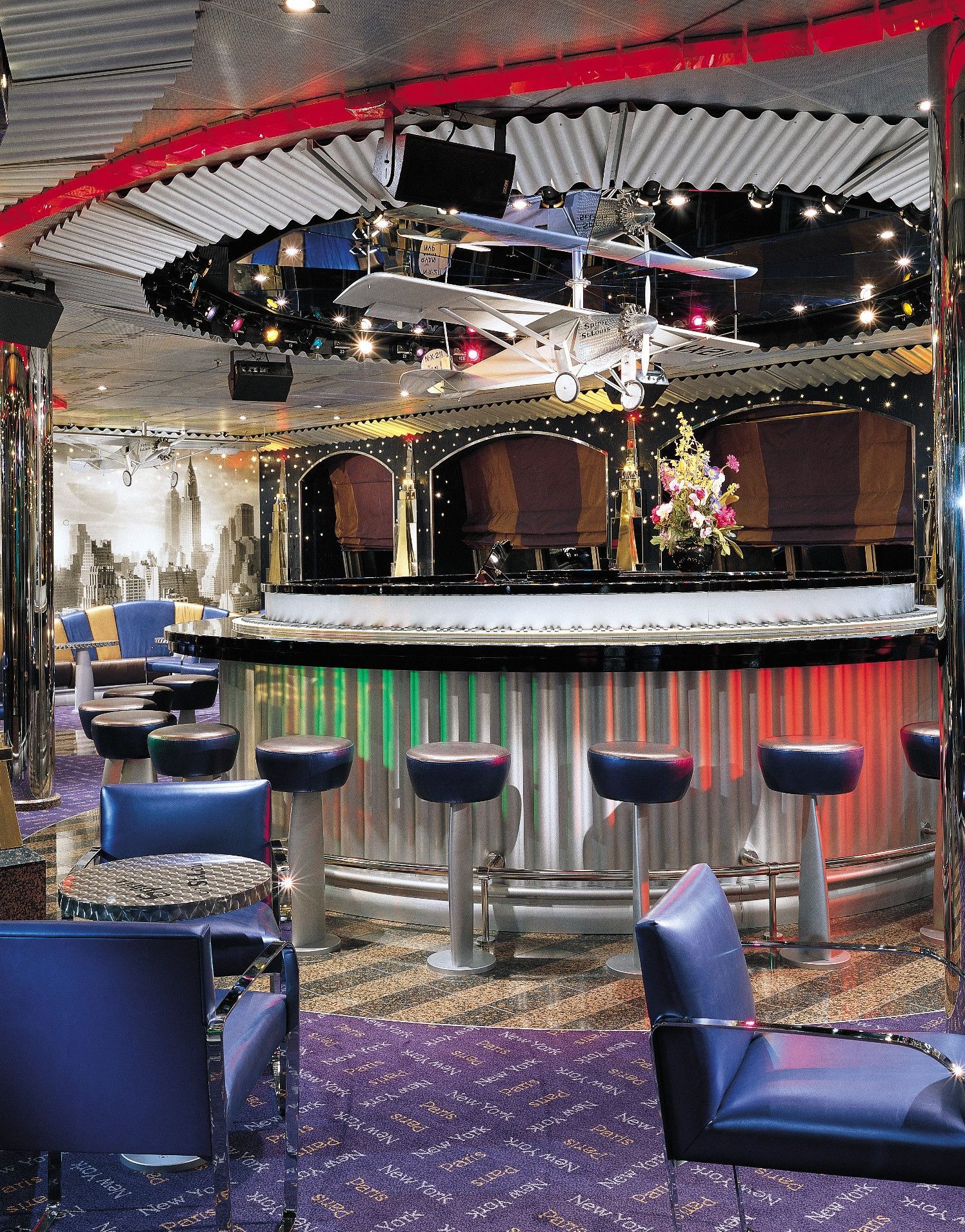 Carnival Valor aviation-themed bar with a vintage biplane overhead and illuminated bar front