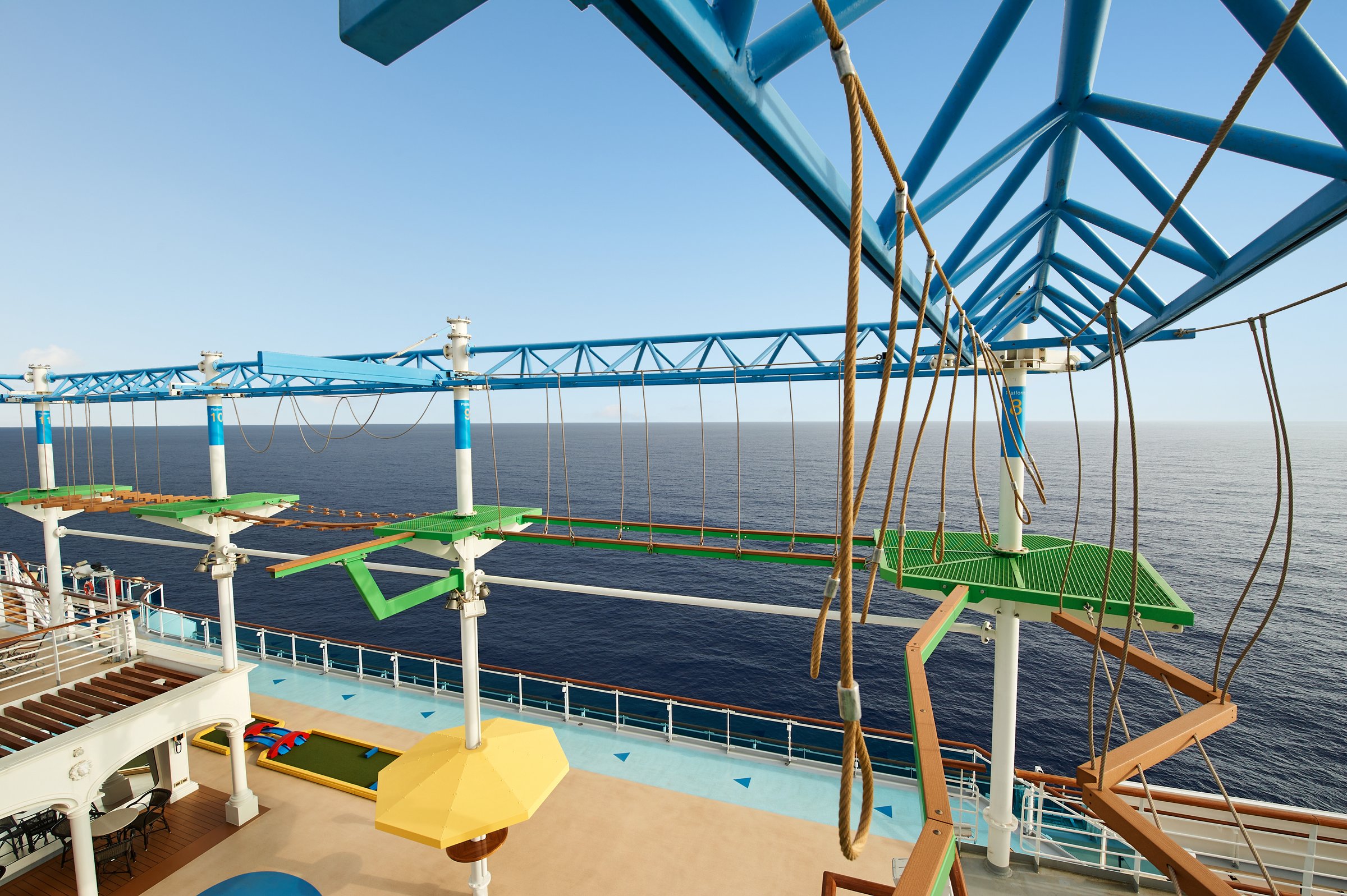 Carnival Venezia ropes course high above the top deck, open ocean beyond