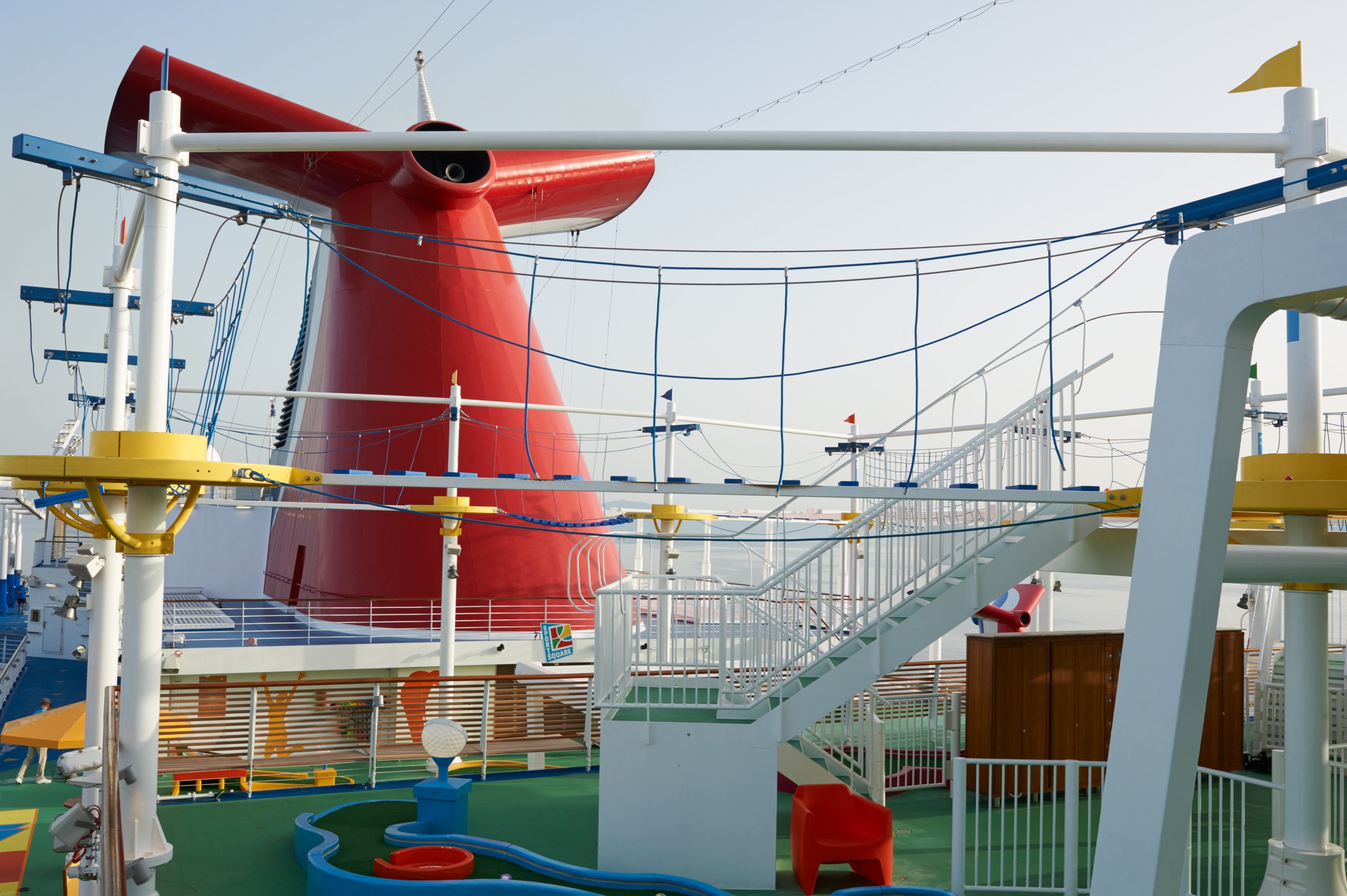 Carnival Vista SkyCourse ropes and mini golf beneath the red funnel on the sports deck
