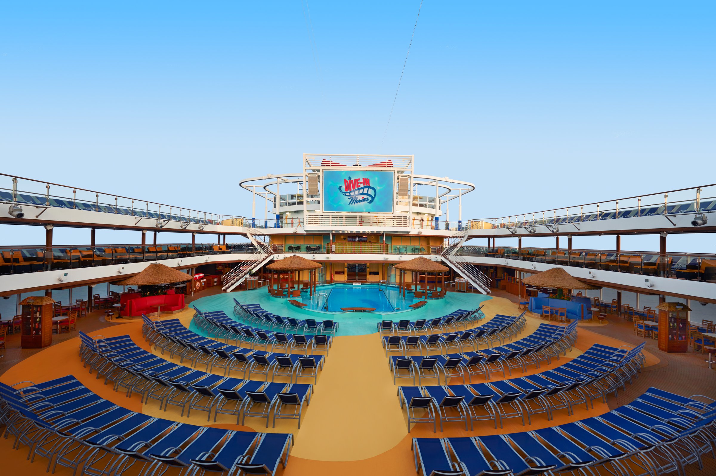 Carnival Vista Lido main pool deck with rows of blue loungers and the Dive-In Movies screen