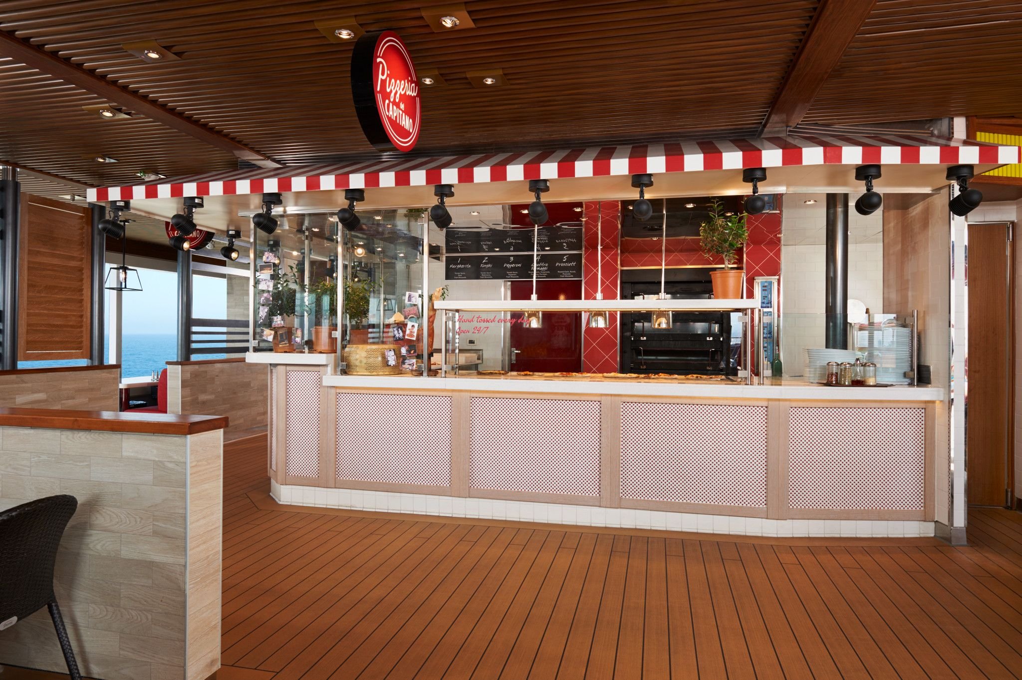 Carnival Vista Pizzeria del Capitano counter with red-and-white striped awning