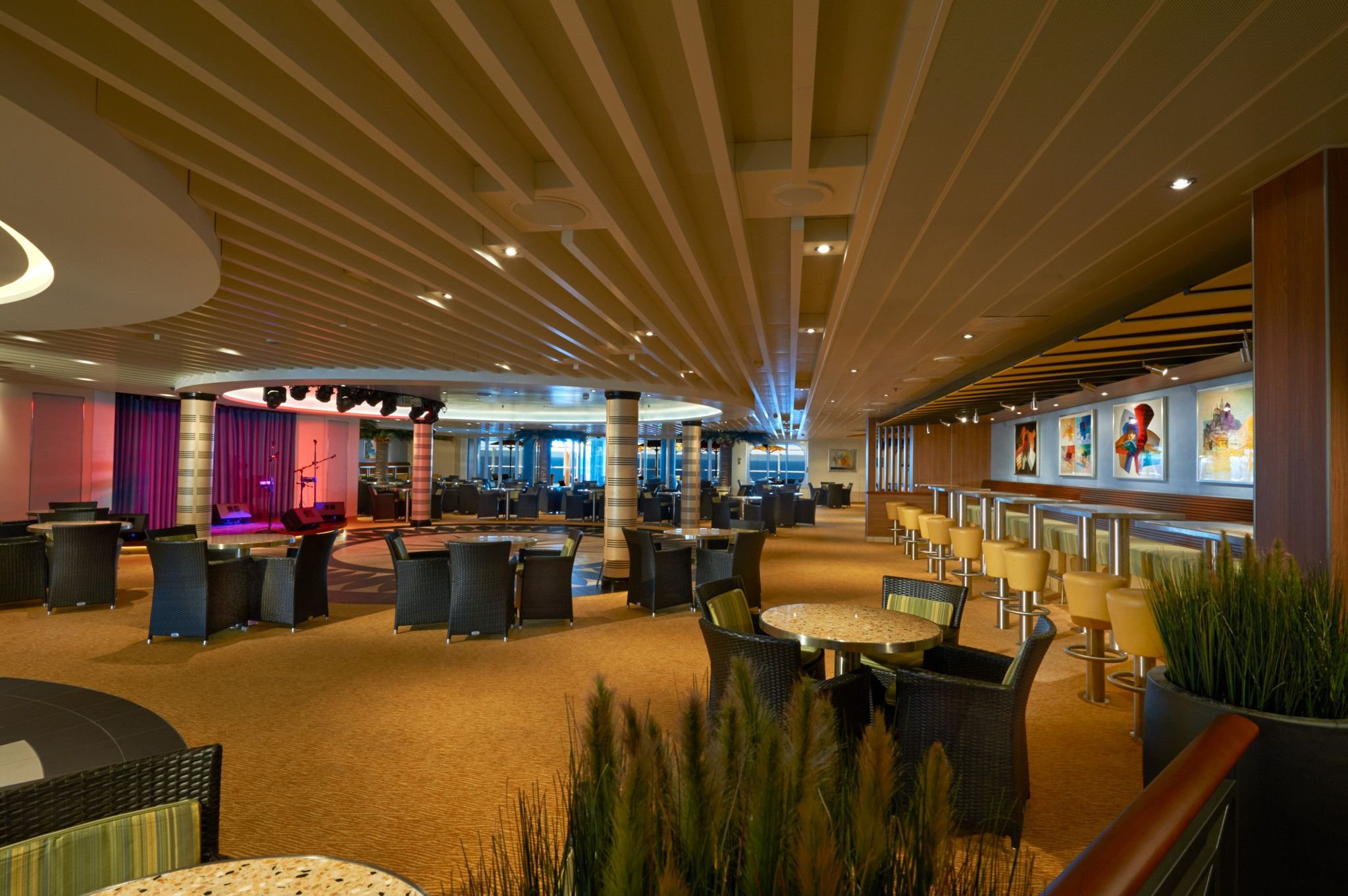 Carnival Vista Ocean Plaza lounge with stage, armchair seating and bar stools