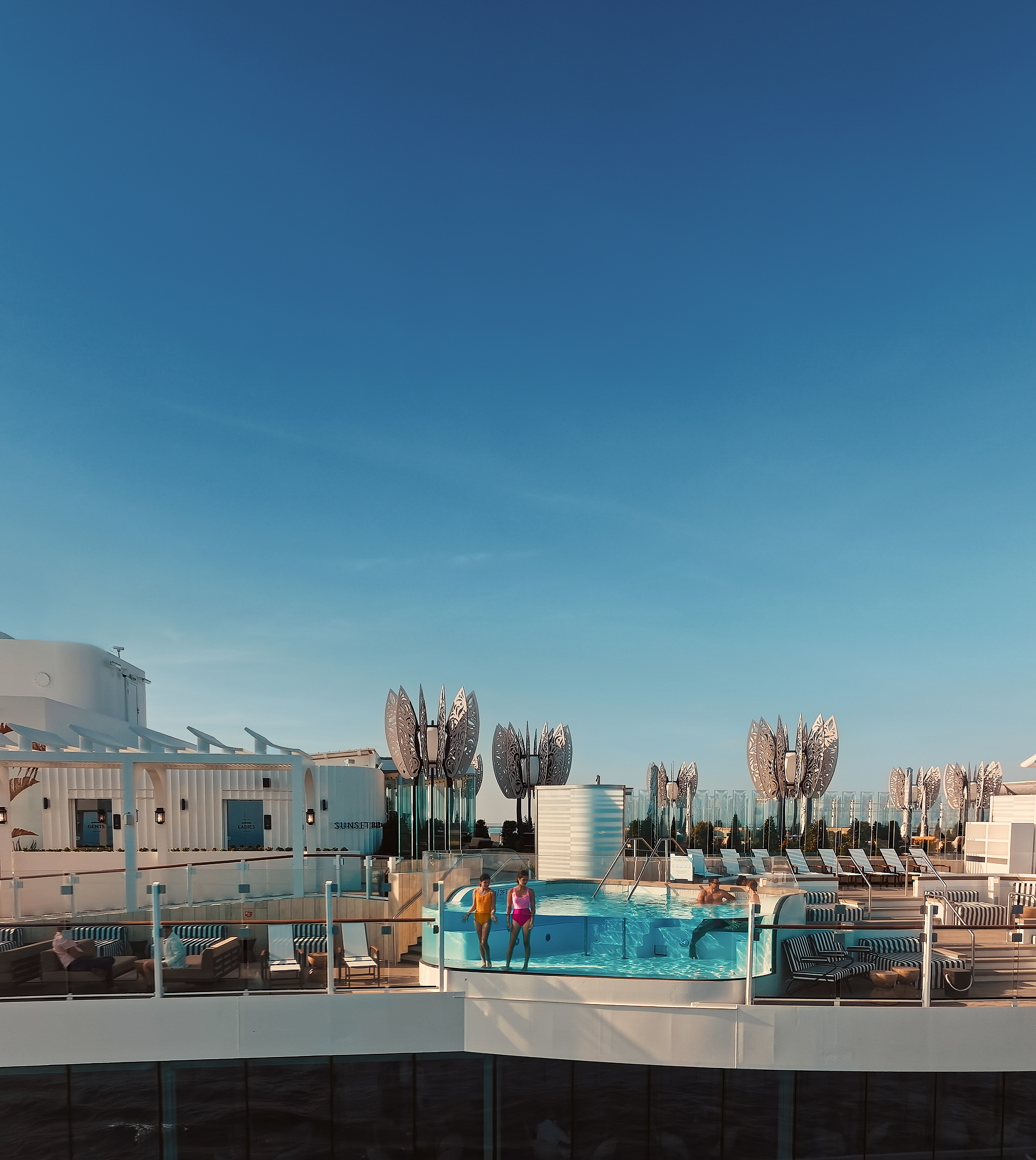 Celebrity Beyond rooftop float pool under a clear blue sky