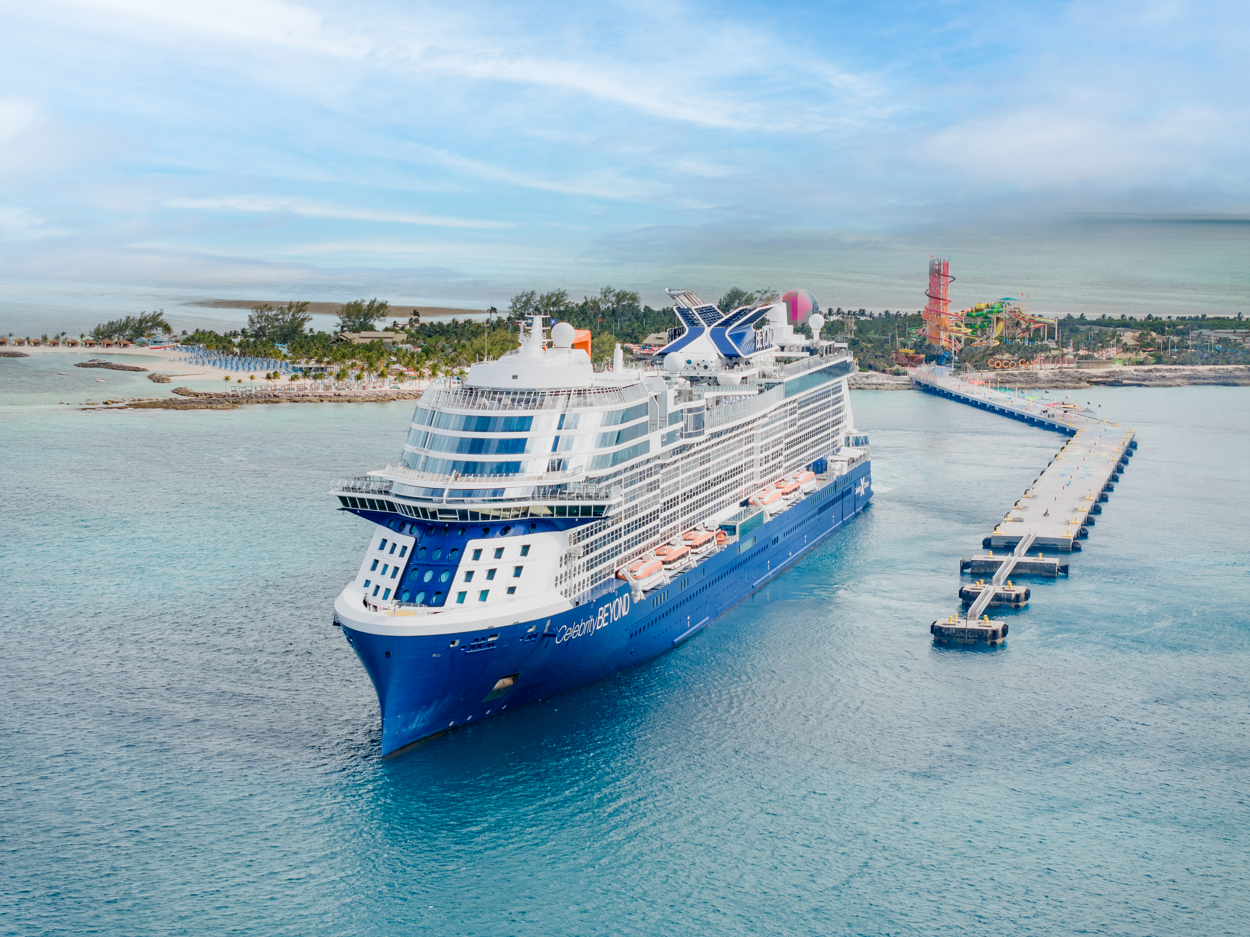 Celebrity Beyond aerial exterior at sunny Perfect Day at CocoCay with BEYOND on the hull