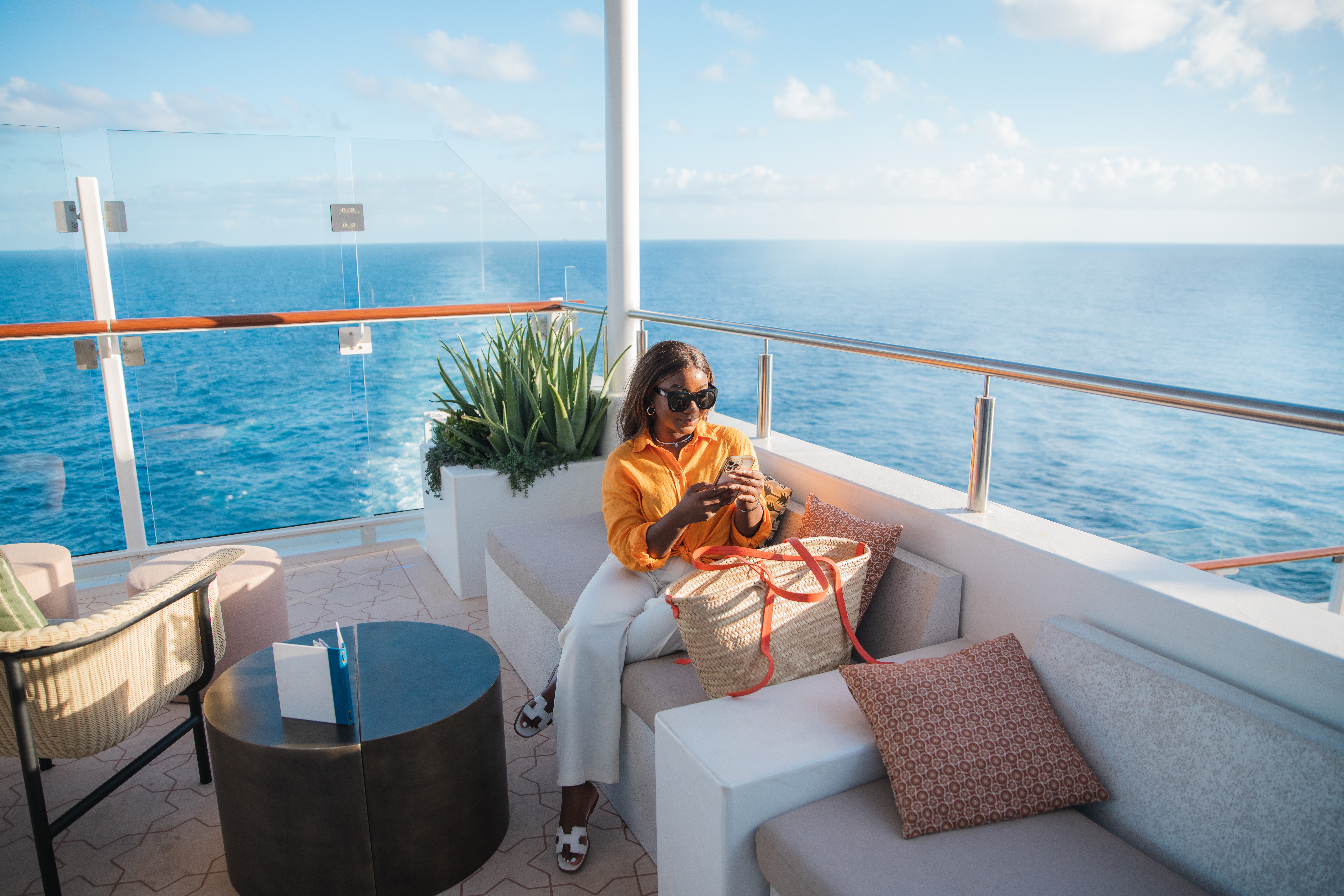 Celebrity Beyond Sunset Bar lounge with sunny ocean wake view