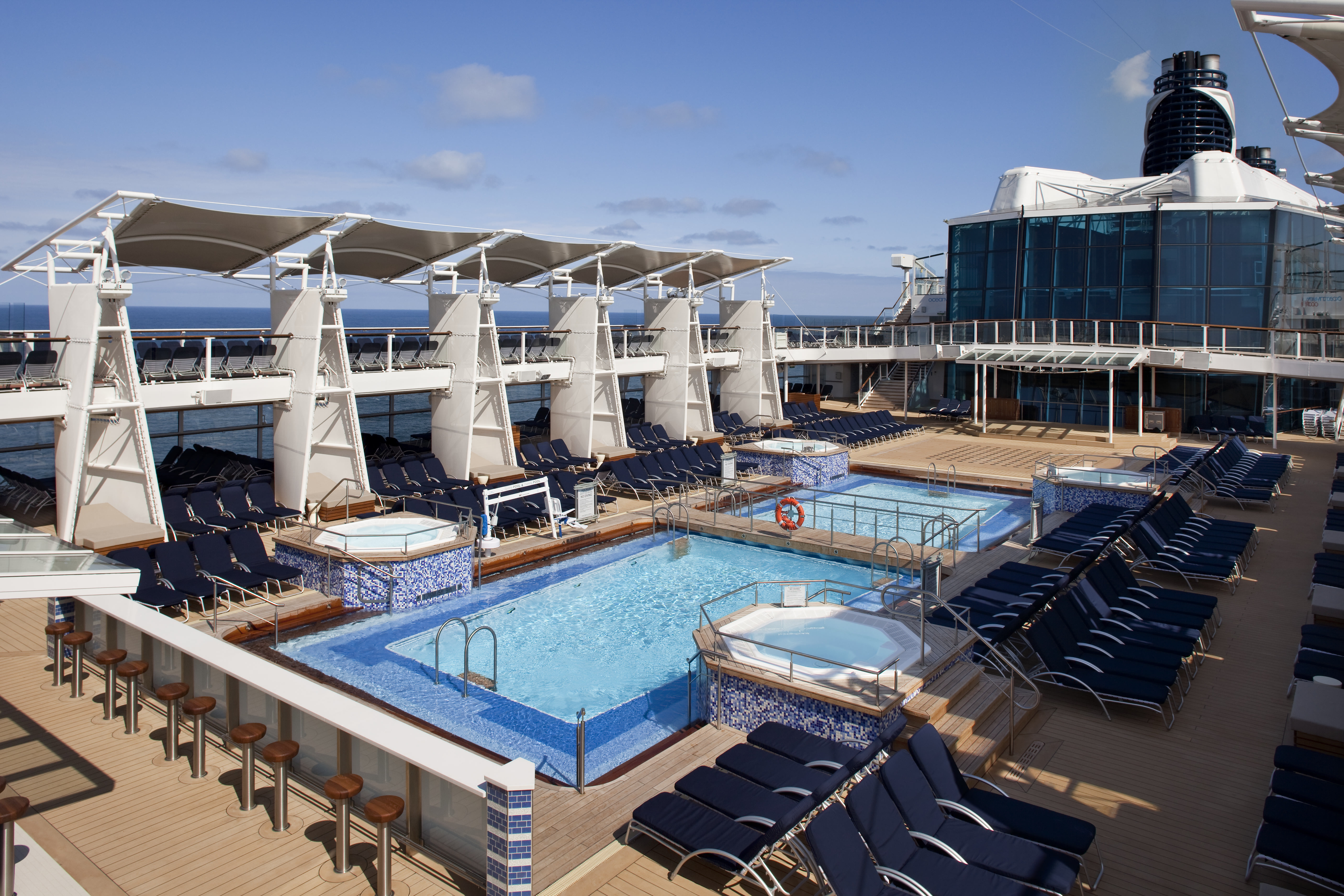 Celebrity Eclipse main pool deck under a bright blue sky