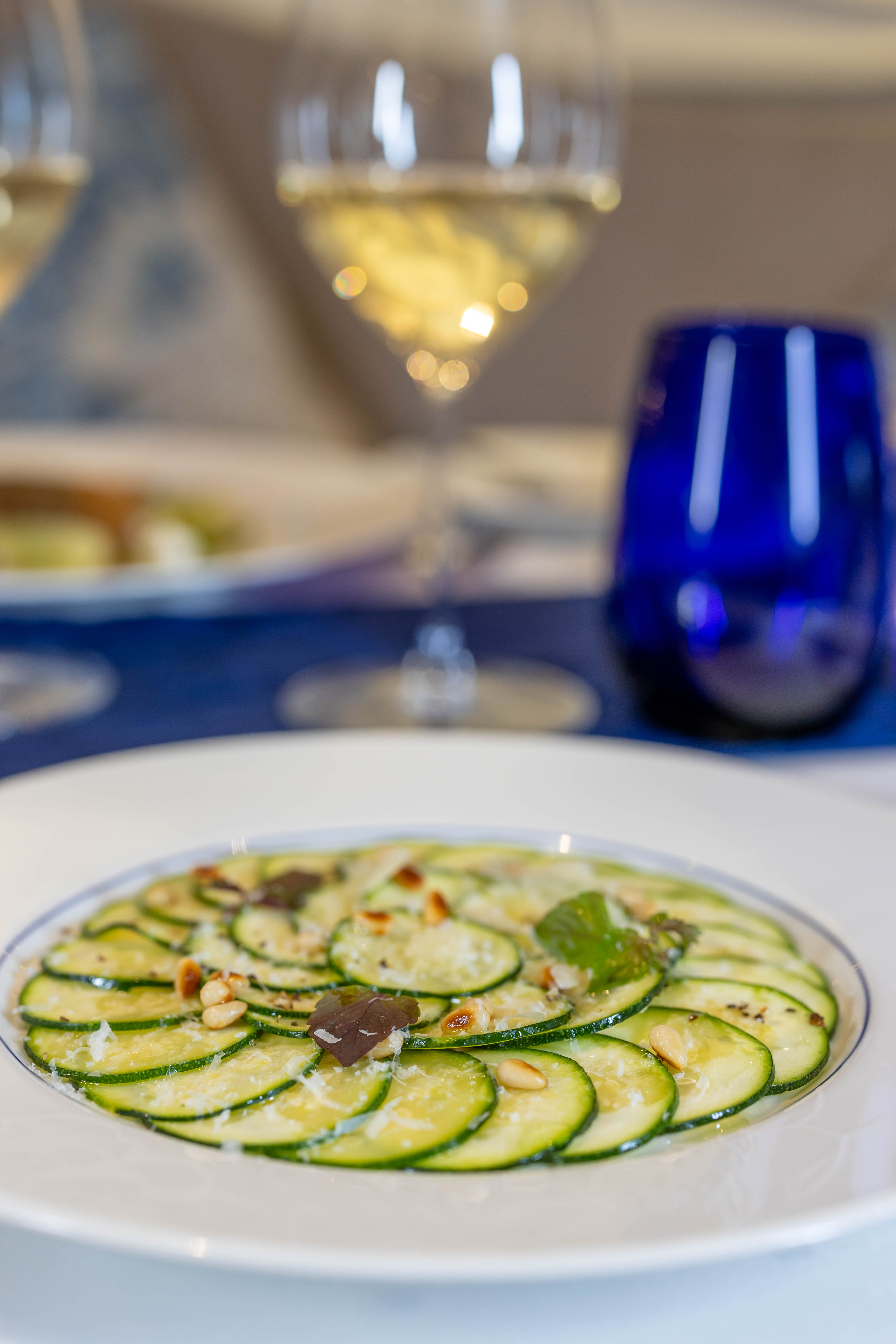 Celebrity Edge Blu restaurant plated dish with signature cobalt glass