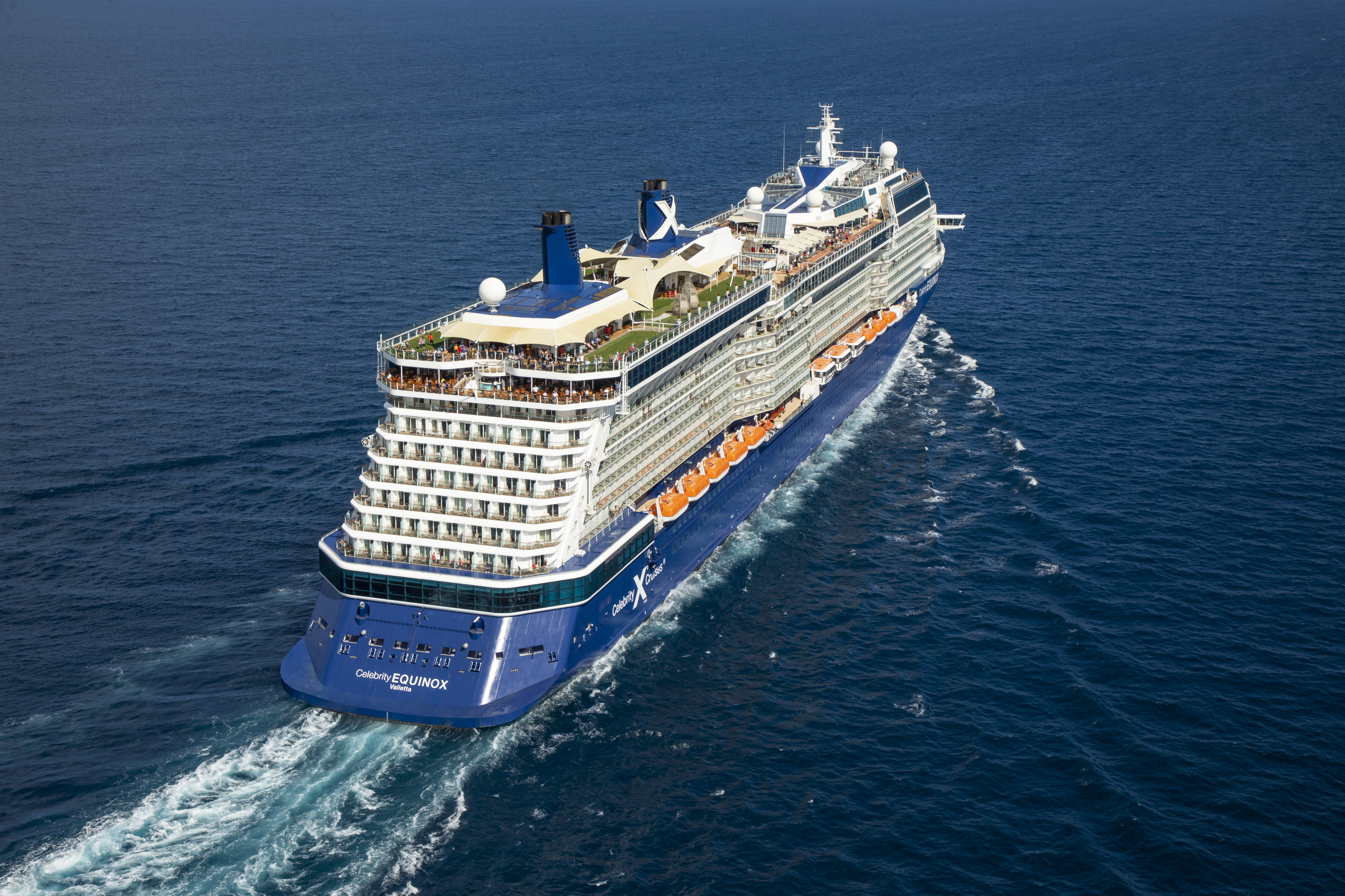Celebrity Equinox sunny aerial exterior underway with EQUINOX on the stern