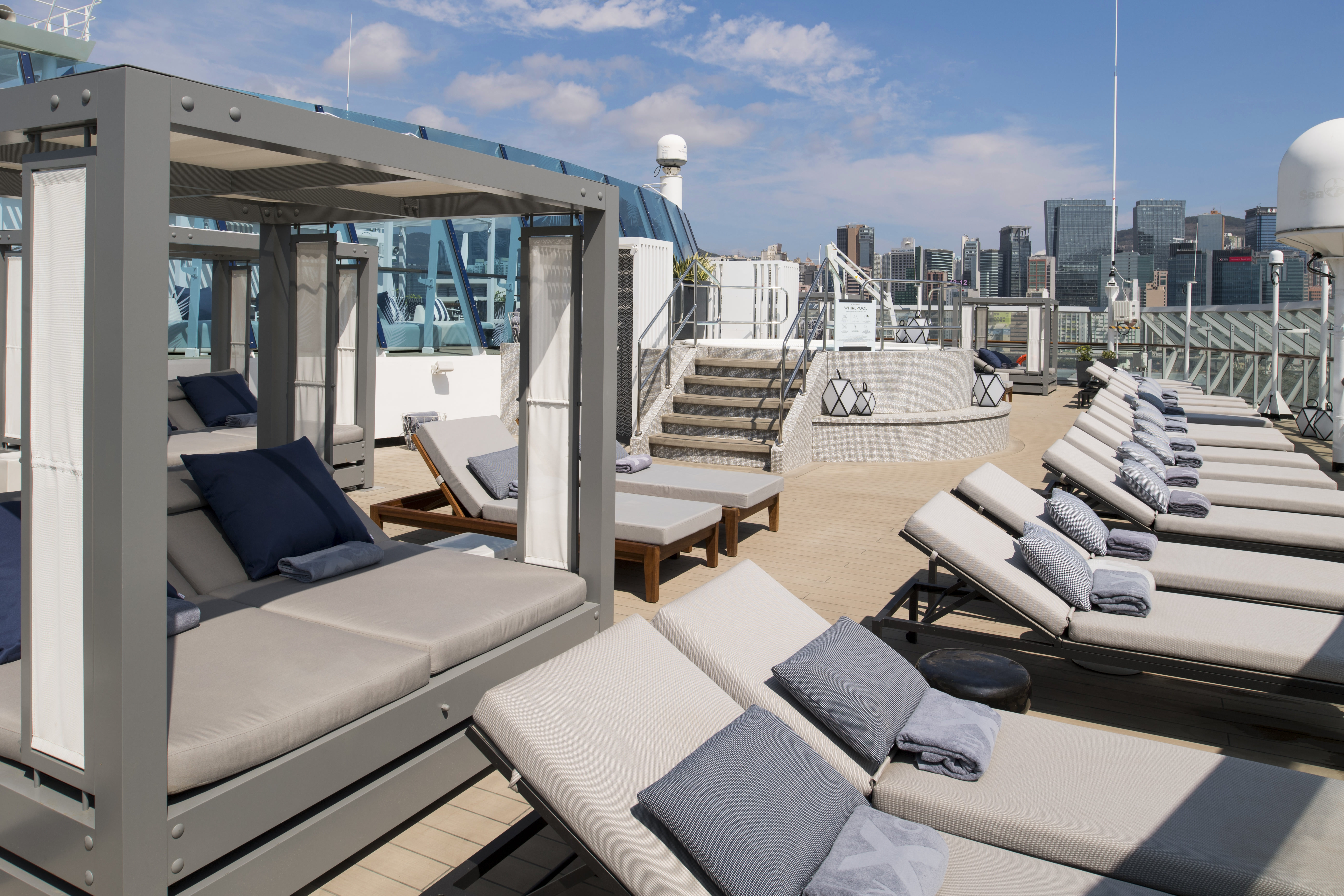Celebrity Millennium The Retreat sundeck with cabanas under a clear sky
