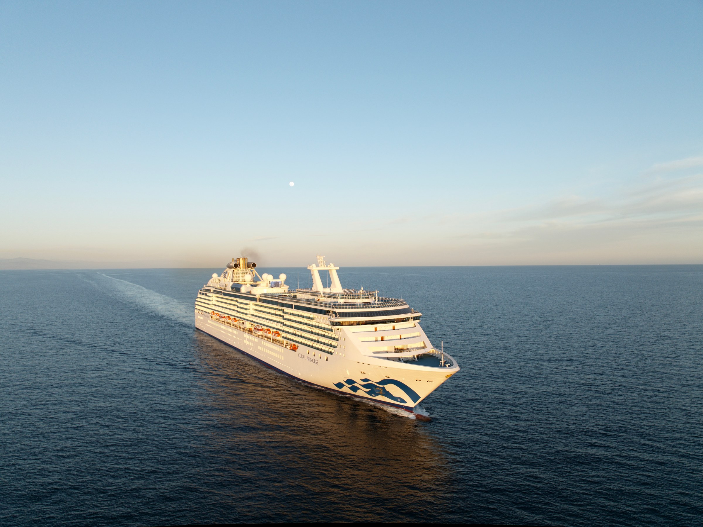 Coral Princess from the air at golden hour on open water