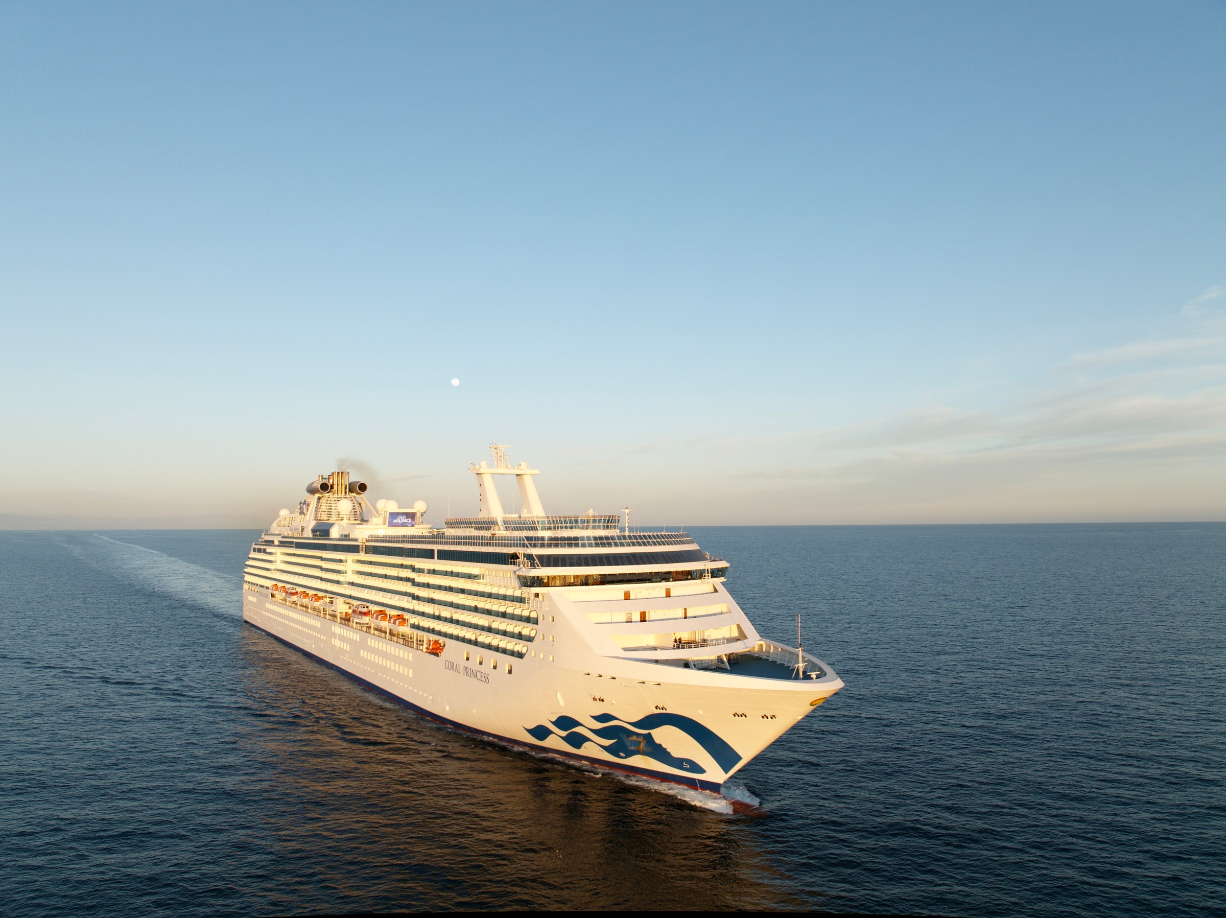 Coral Princess aerial at golden hour with sun on the water