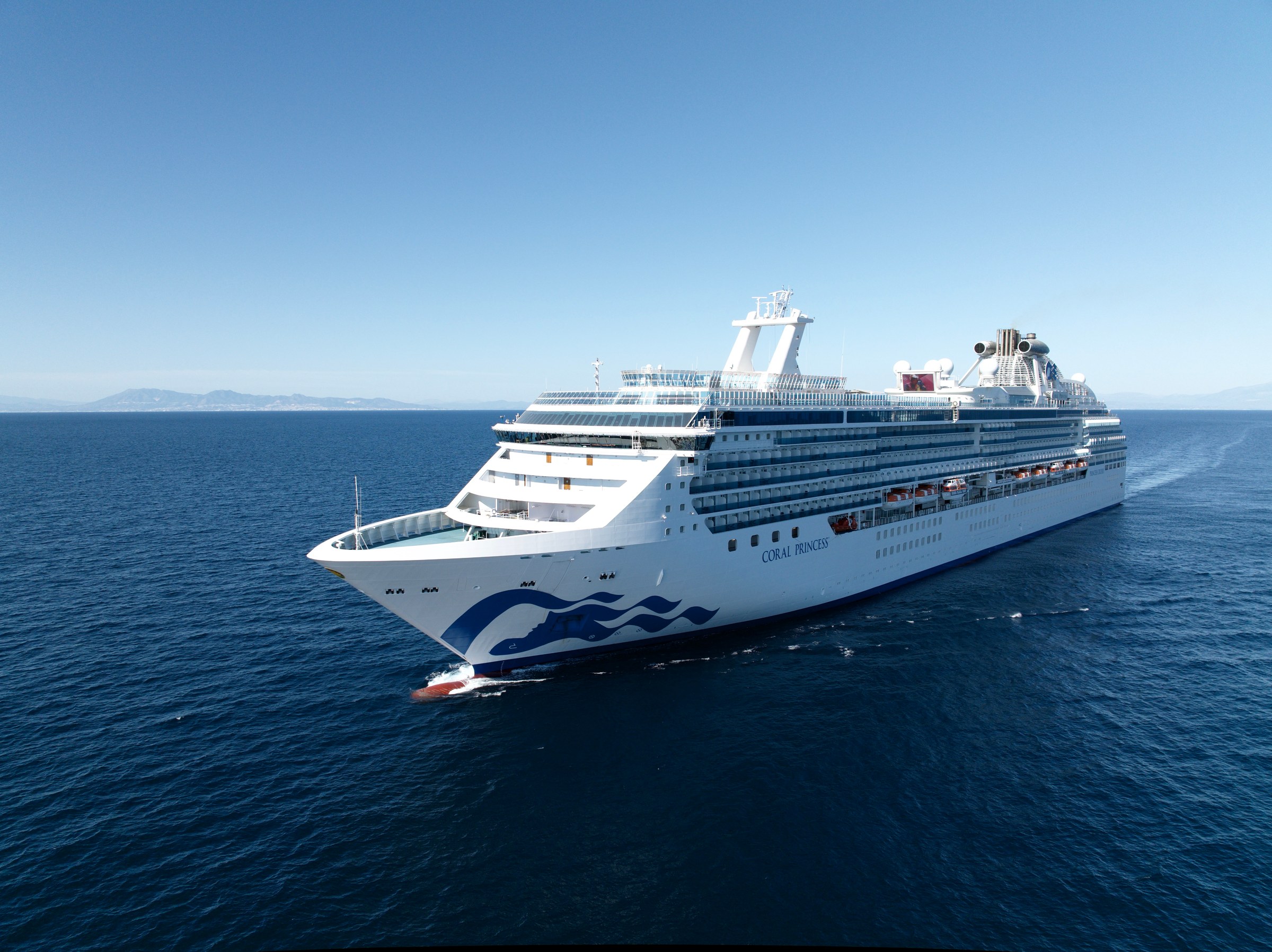 Coral Princess bow aerial sailing calm blue water