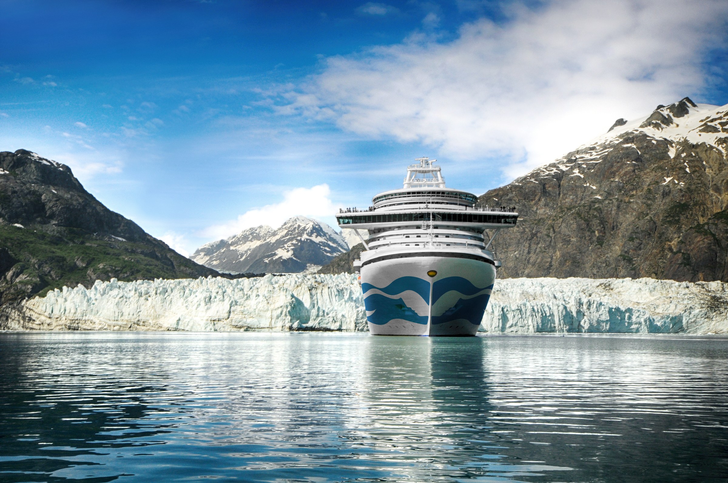 Crown Princess bow-on in front of a glacier in Glacier Bay, Alaska, on a sunny day