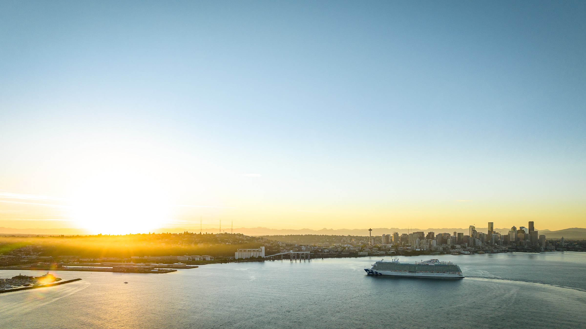 Discovery Princess sailing Elliott Bay near Seattle at golden hour