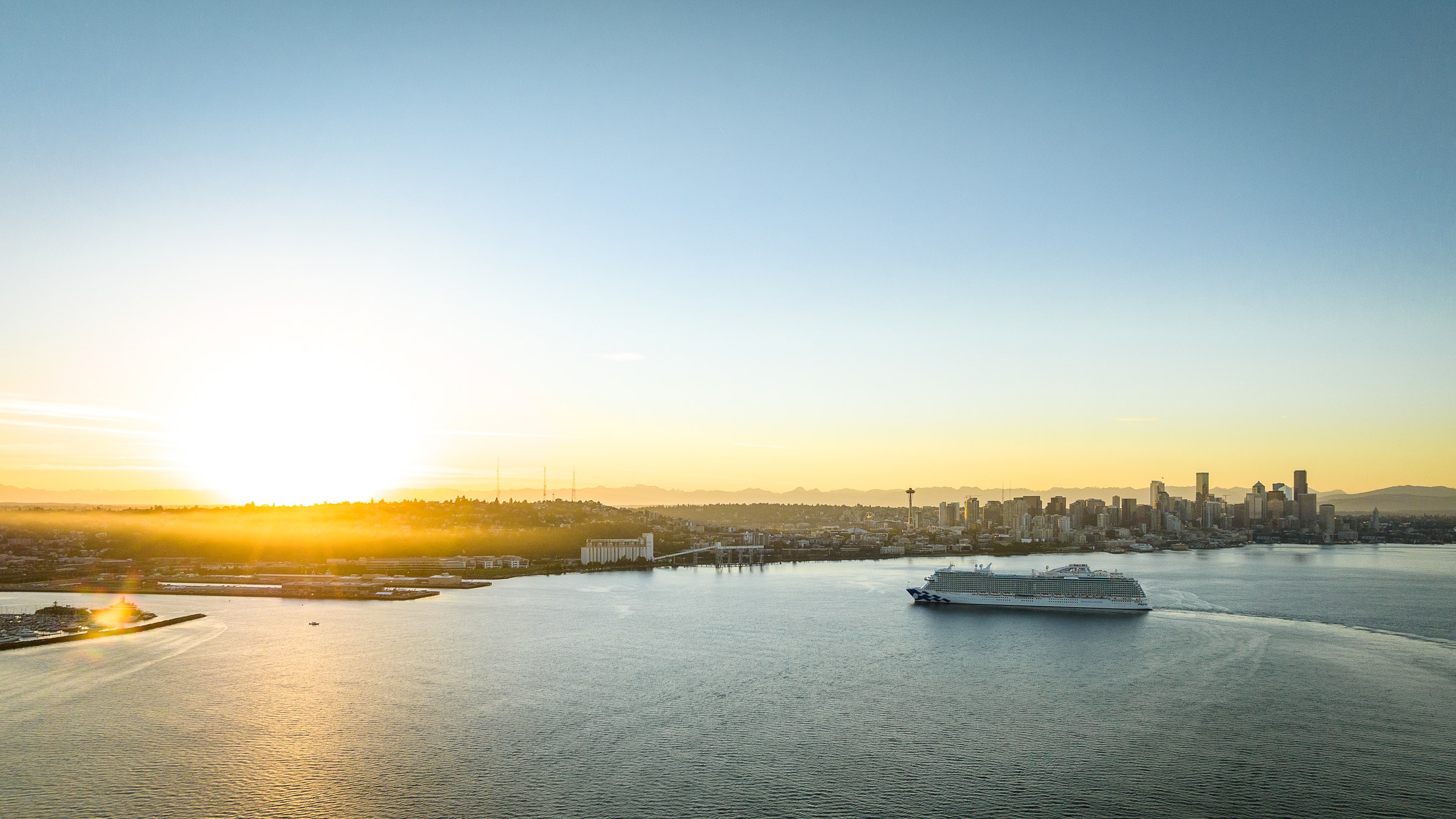 Discovery Princess sailing Elliott Bay near Seattle at golden hour