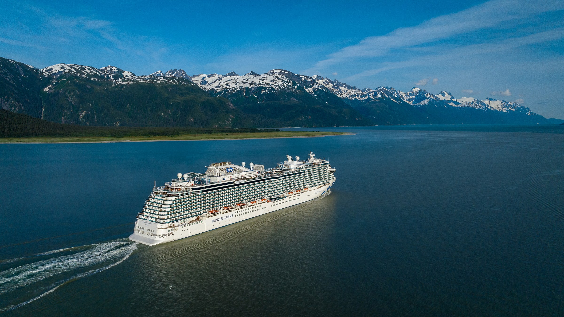 Discovery Princess sailing Haines, Alaska, with snowy peaks behind