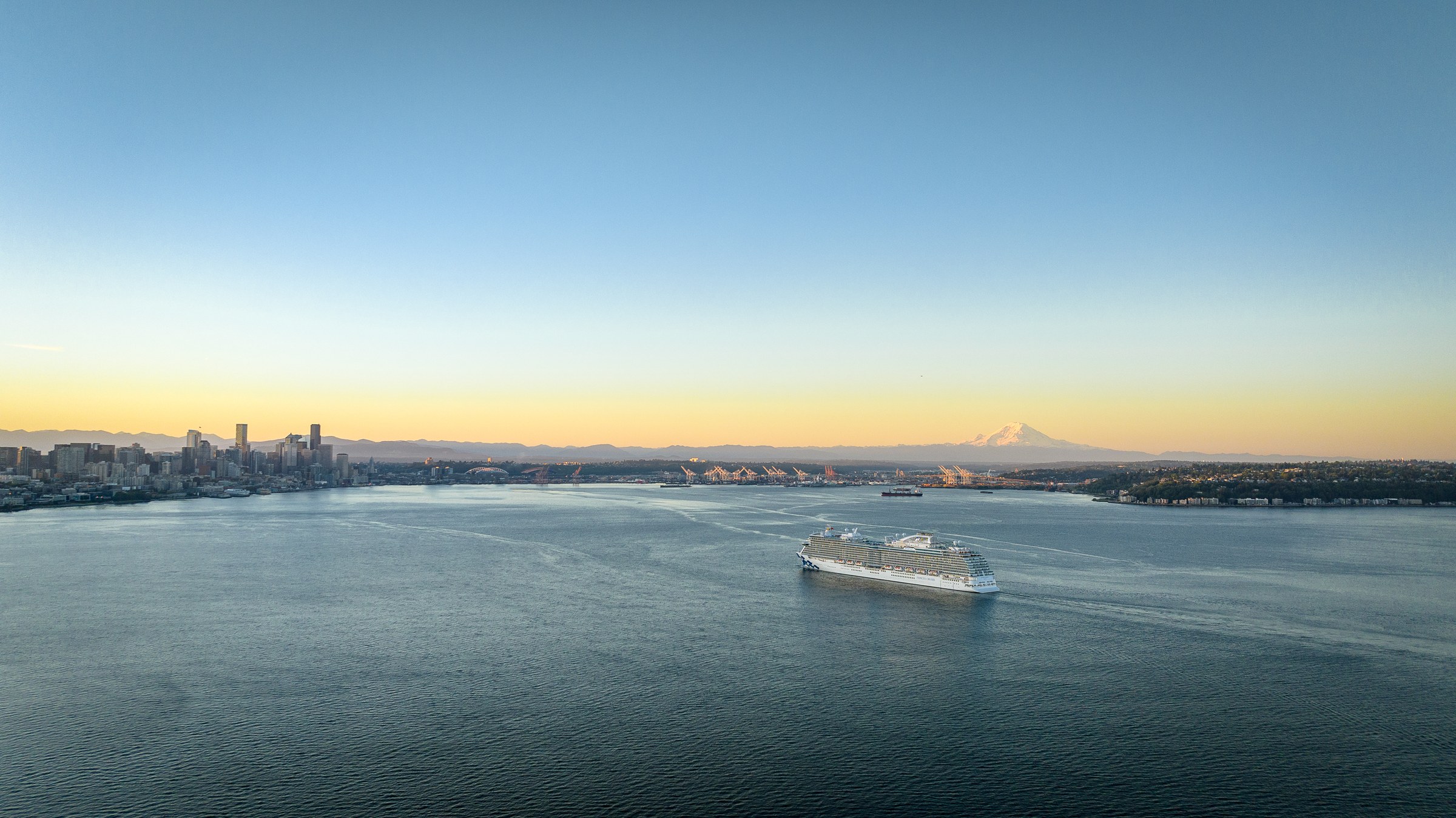 Discovery Princess sailing Elliott Bay near Seattle at golden hour