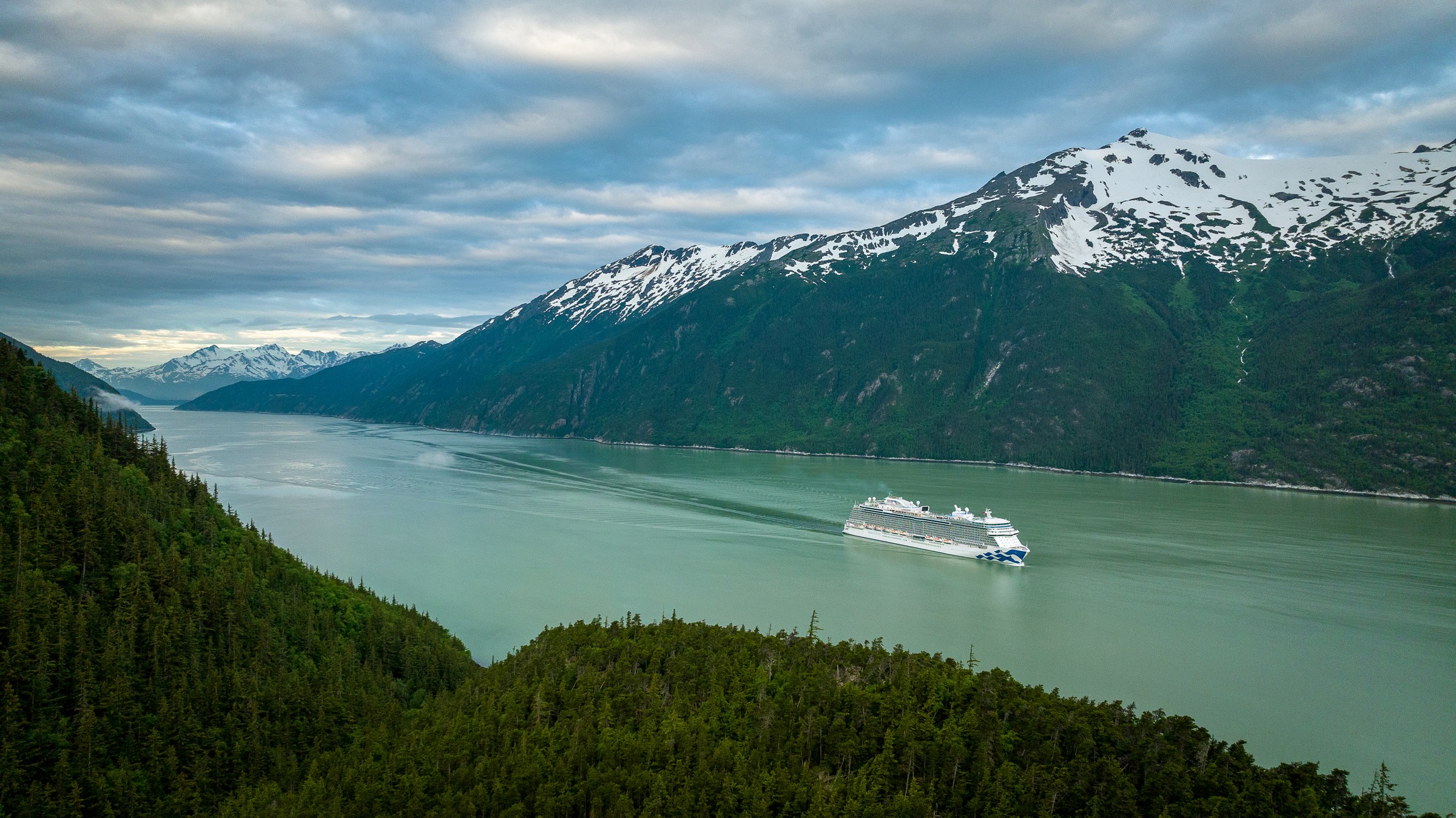 Discovery Princess aerial in Skagway, Alaska, against green mountains