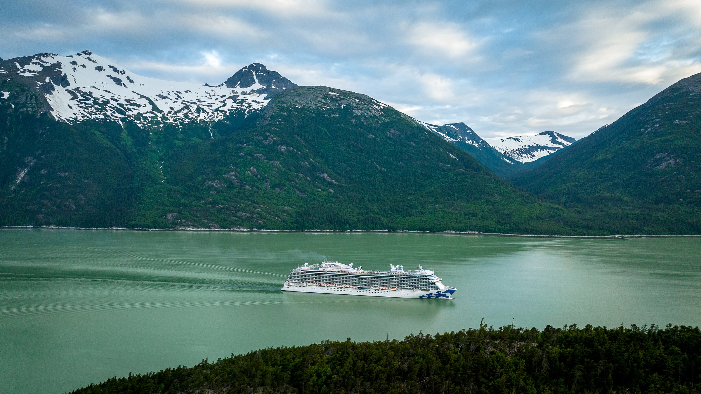 Discovery Princess aerial in Skagway, Alaska, against green mountains