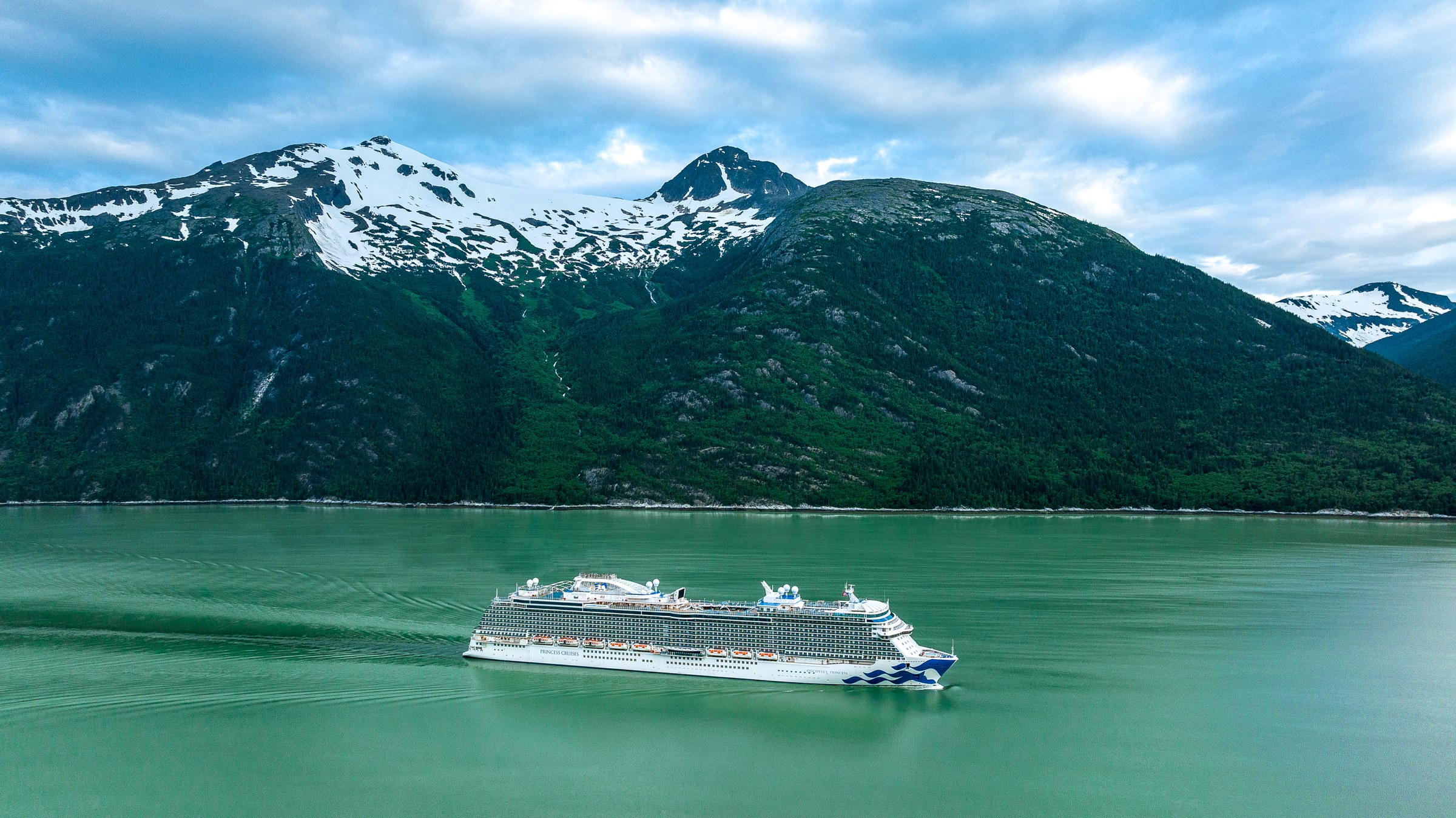 Discovery Princess aerial in Skagway, Alaska, against green mountains