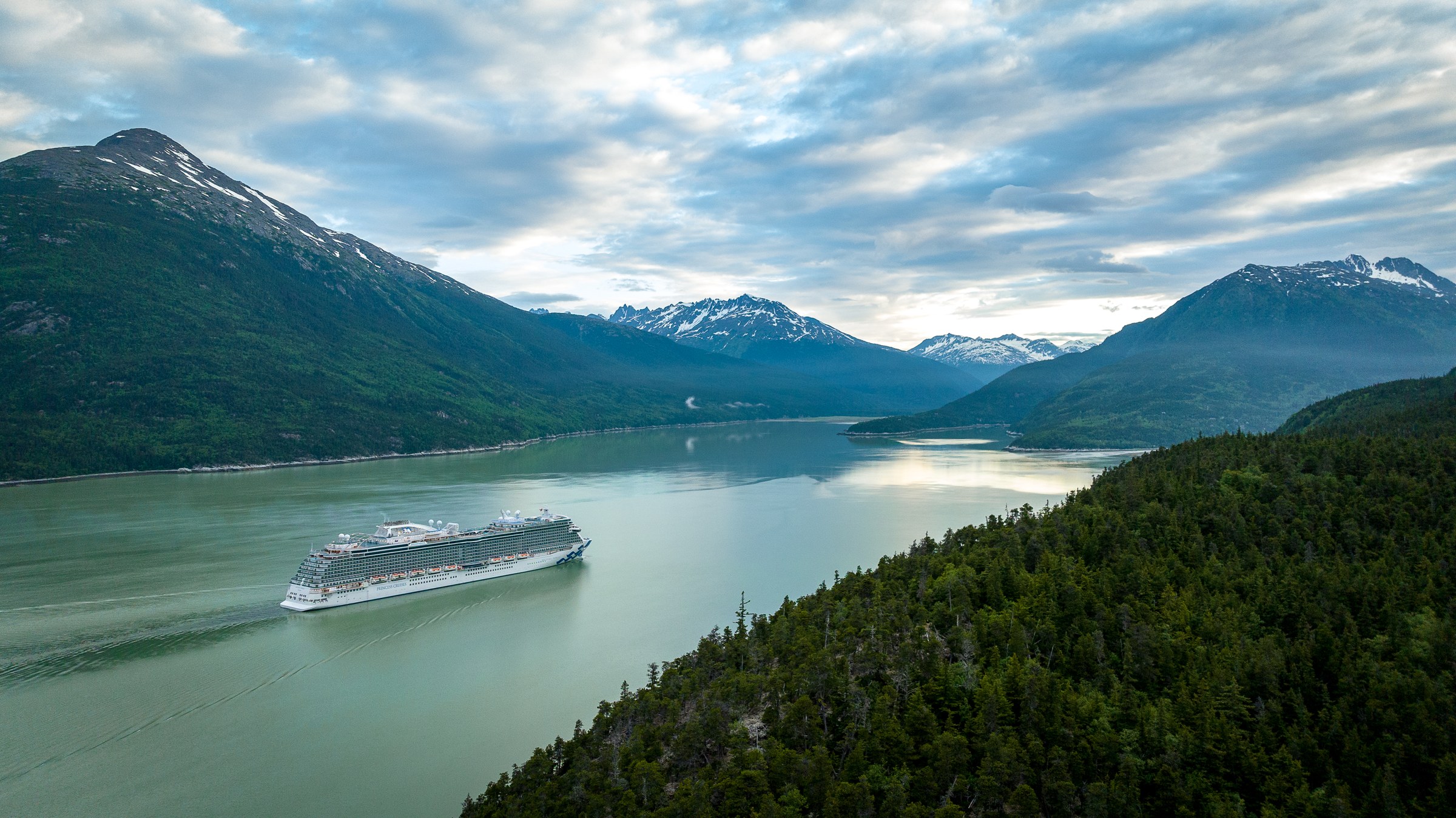 Discovery Princess aerial in Skagway, Alaska, against green mountains