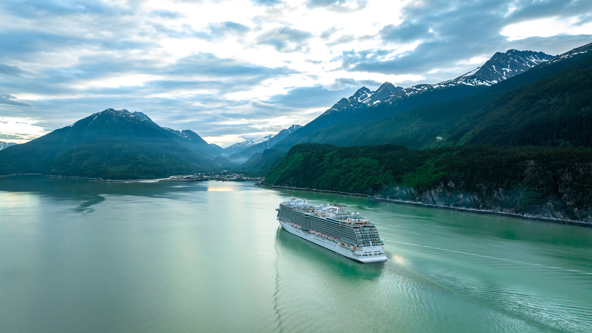 Discovery Princess aerial in Skagway, Alaska, against green mountains
