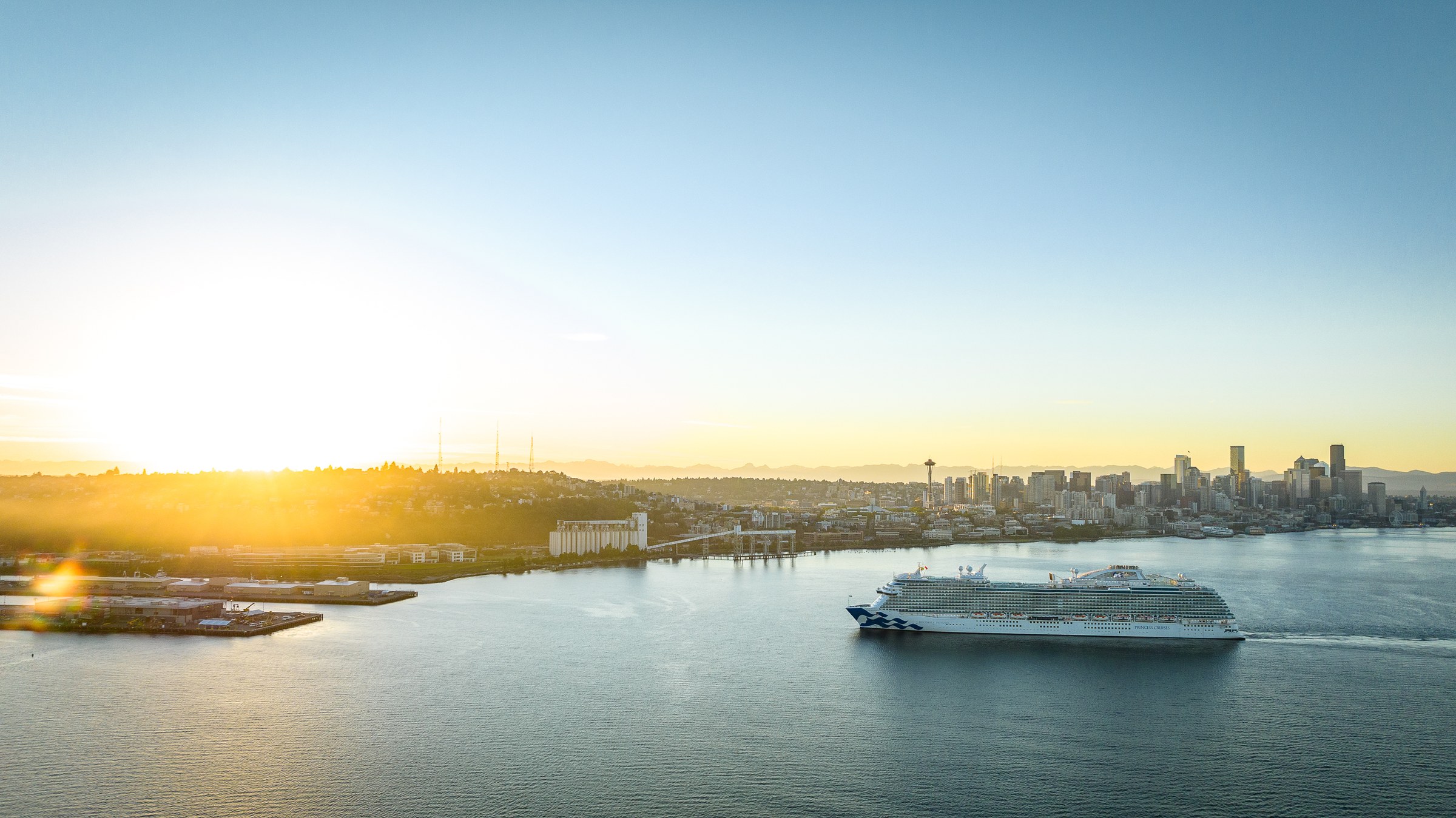 Discovery Princess sailing Elliott Bay near Seattle at golden hour