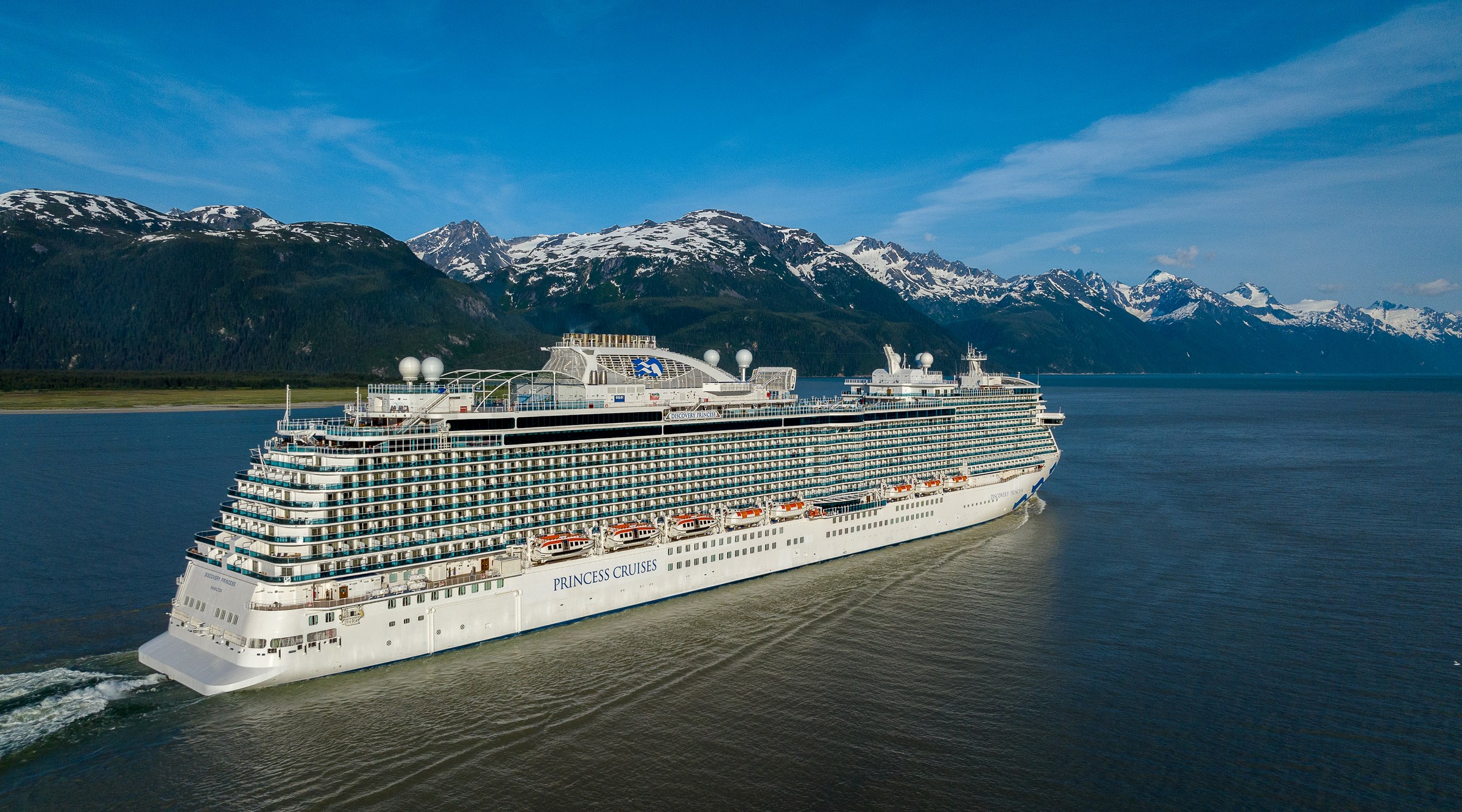 Discovery Princess sailing Haines, Alaska, with snowy peaks behind