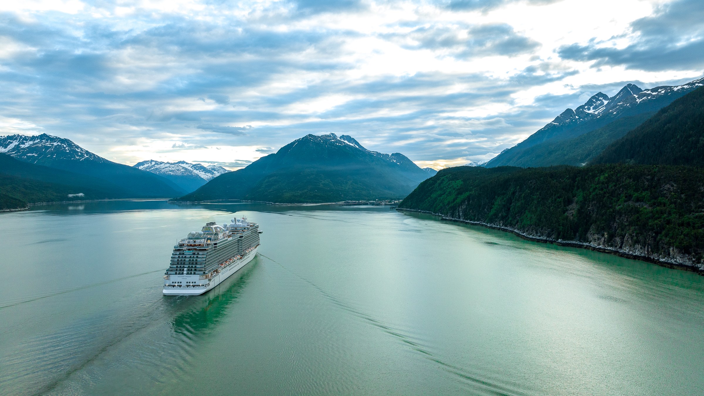 Discovery Princess aerial in Skagway, Alaska, against green mountains