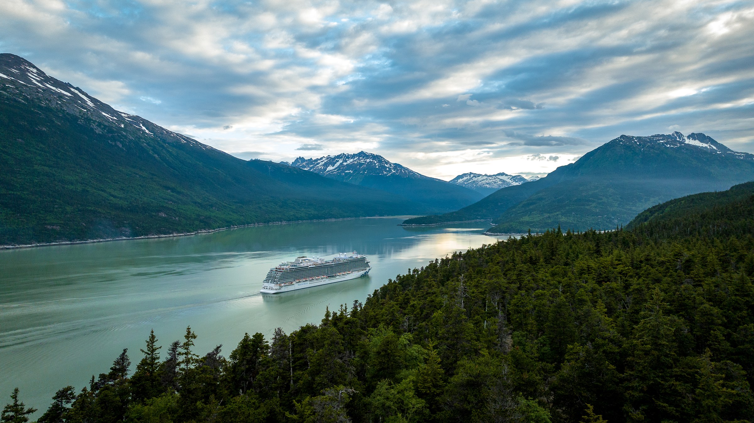 Discovery Princess aerial in Skagway, Alaska, against green mountains