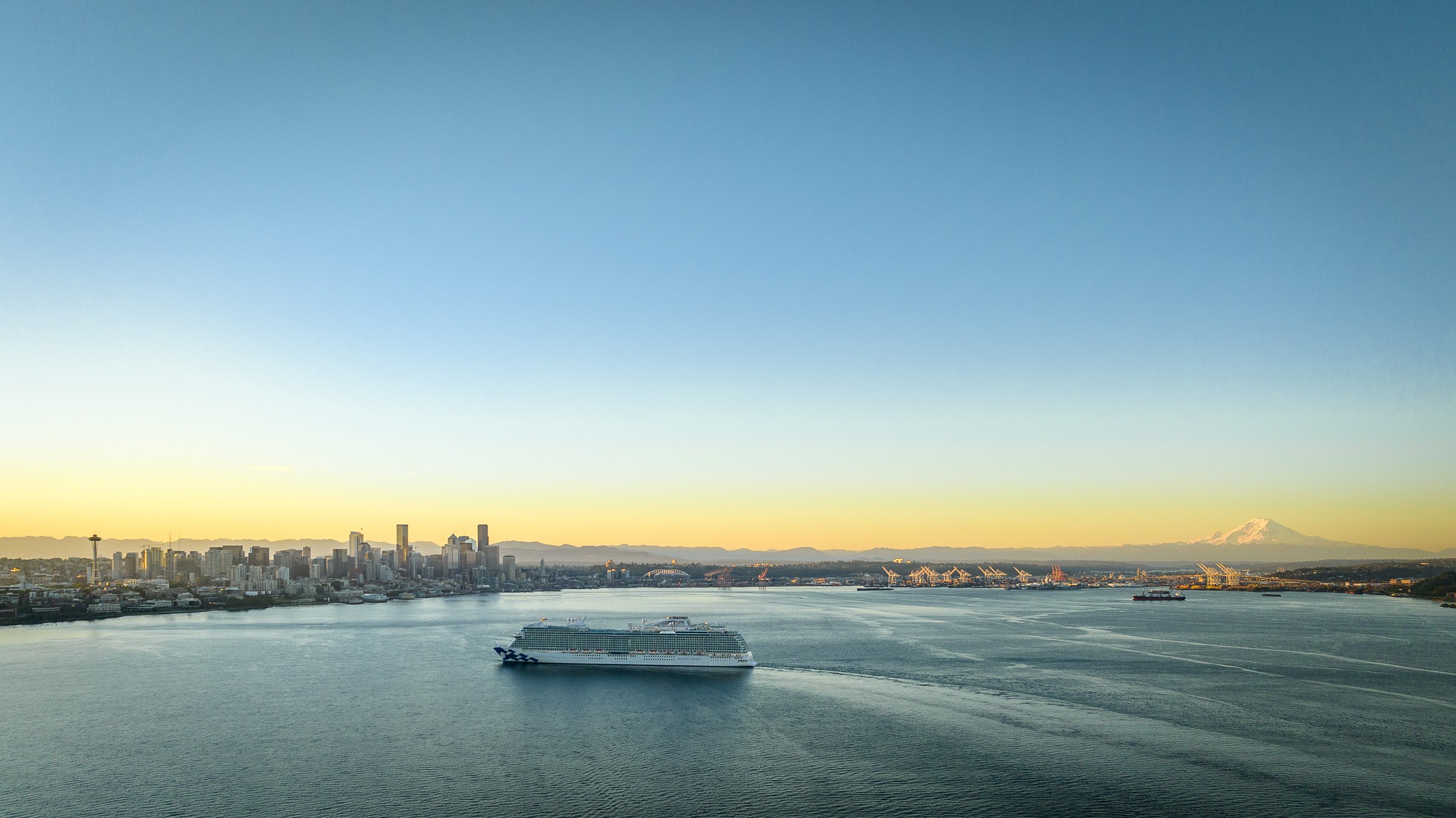Discovery Princess sailing Elliott Bay near Seattle at golden hour