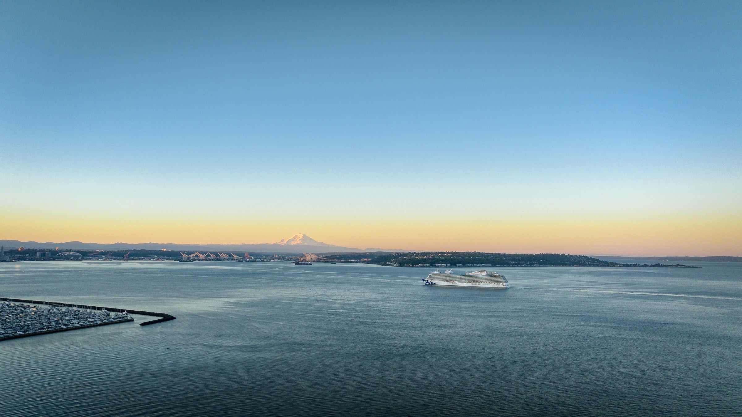 Discovery Princess sailing Elliott Bay near Seattle at golden hour