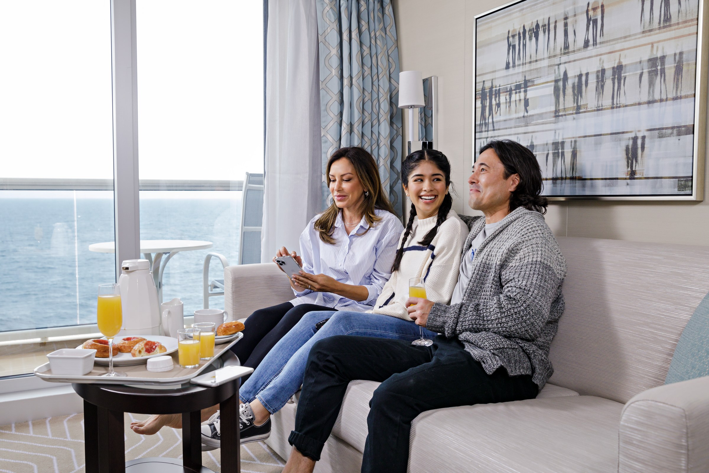 Guests relaxing in a Discovery Princess Mini-Suite with ocean views