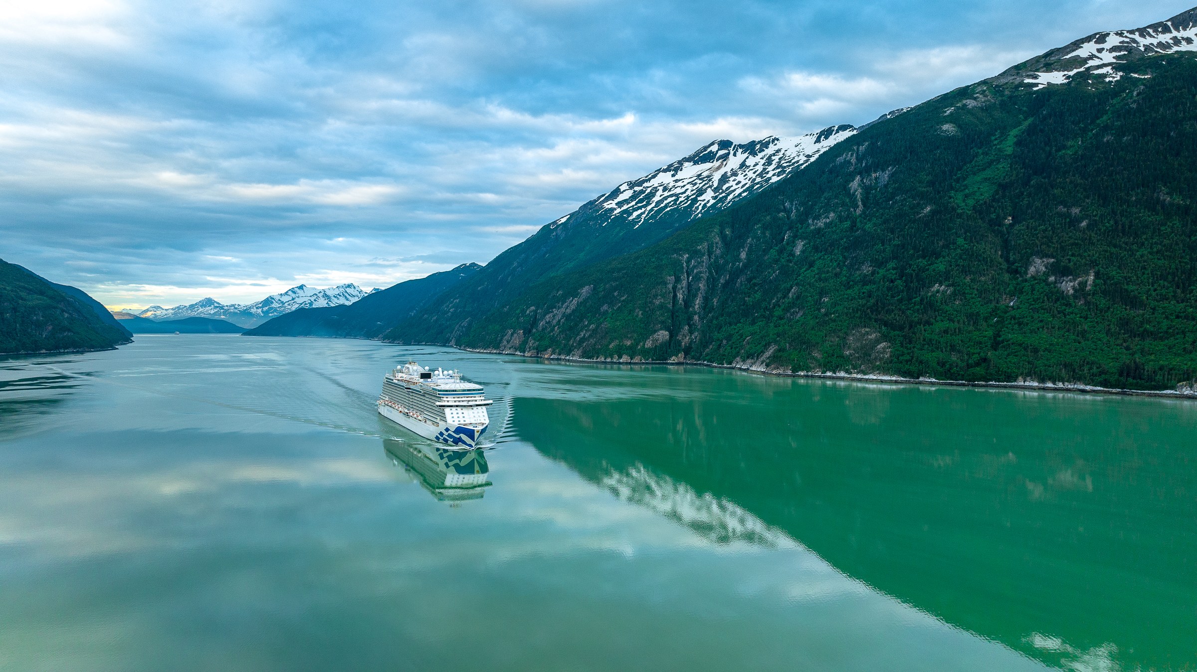 Discovery Princess aerial in Skagway, Alaska, against green mountains