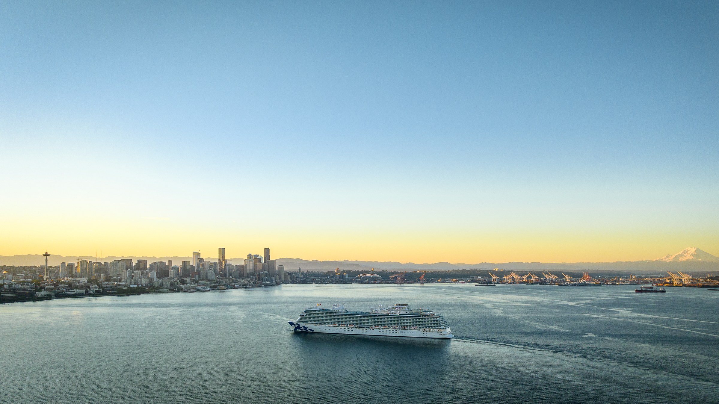Discovery Princess sailing Elliott Bay near Seattle at golden hour