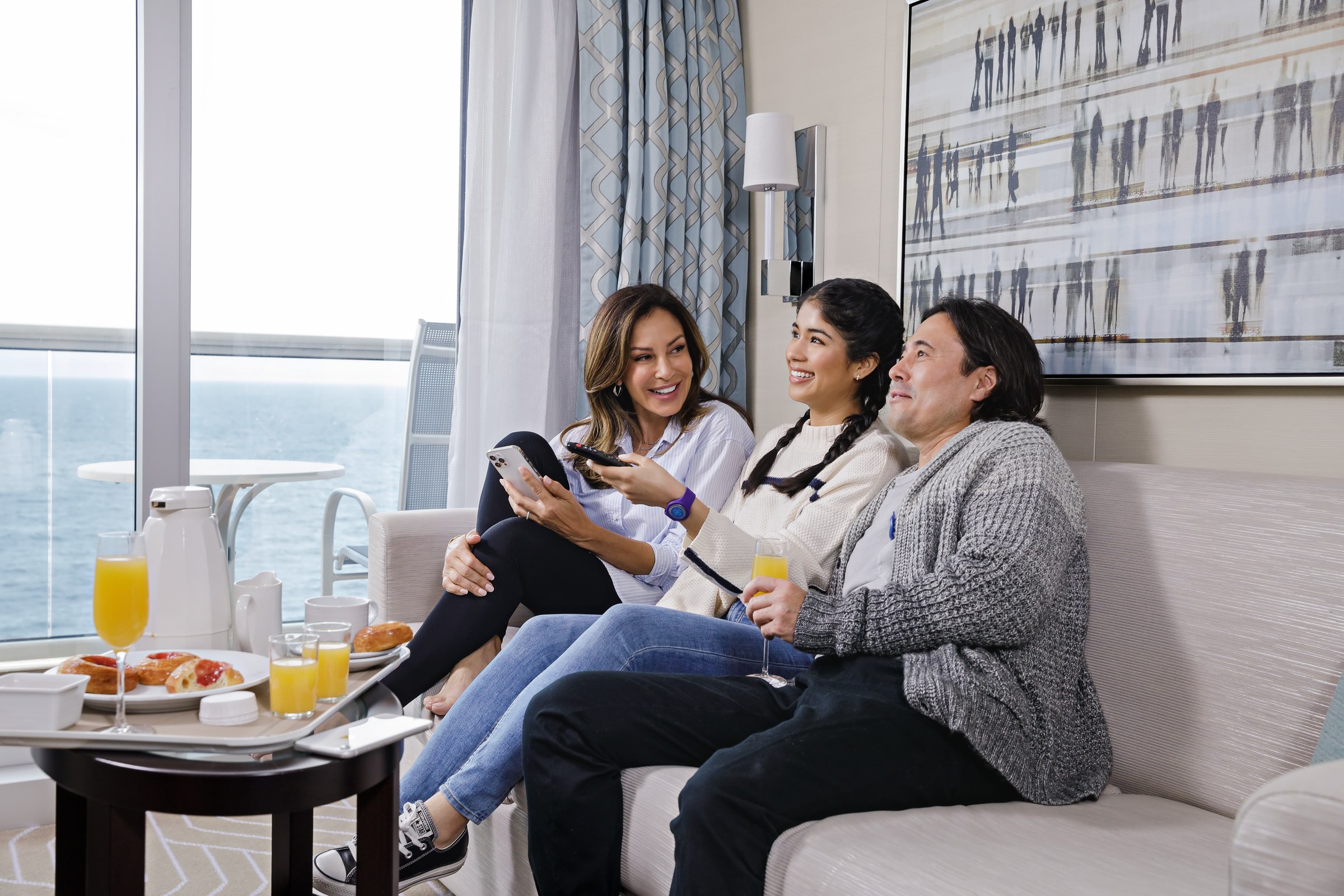 Guests relaxing in a Discovery Princess Mini-Suite with ocean views