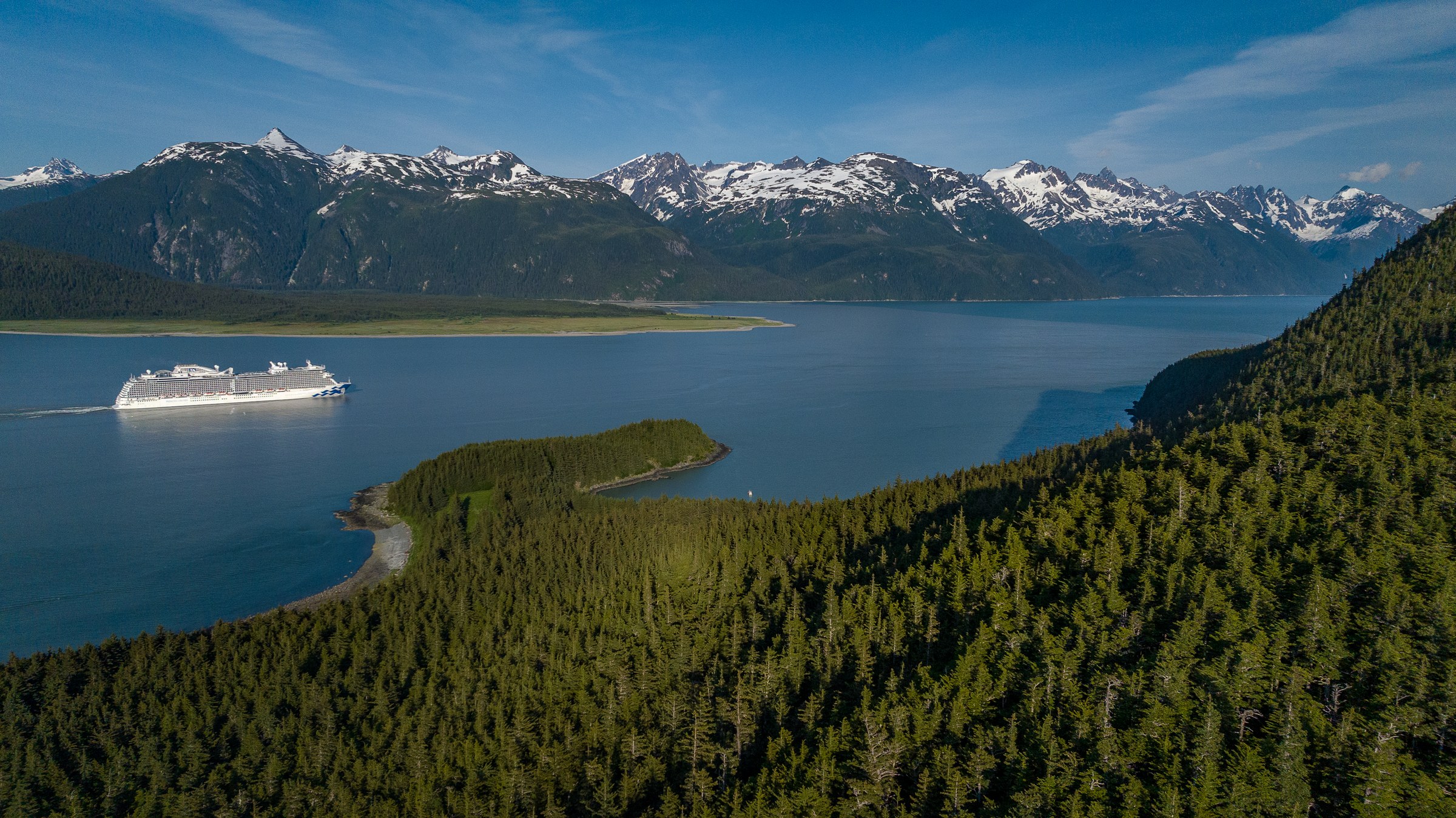 Discovery Princess sailing Haines, Alaska, with snowy peaks behind