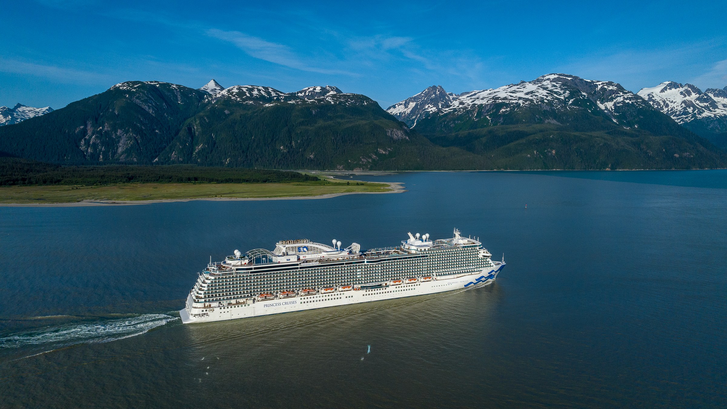 Discovery Princess sailing Haines, Alaska, with snowy peaks behind