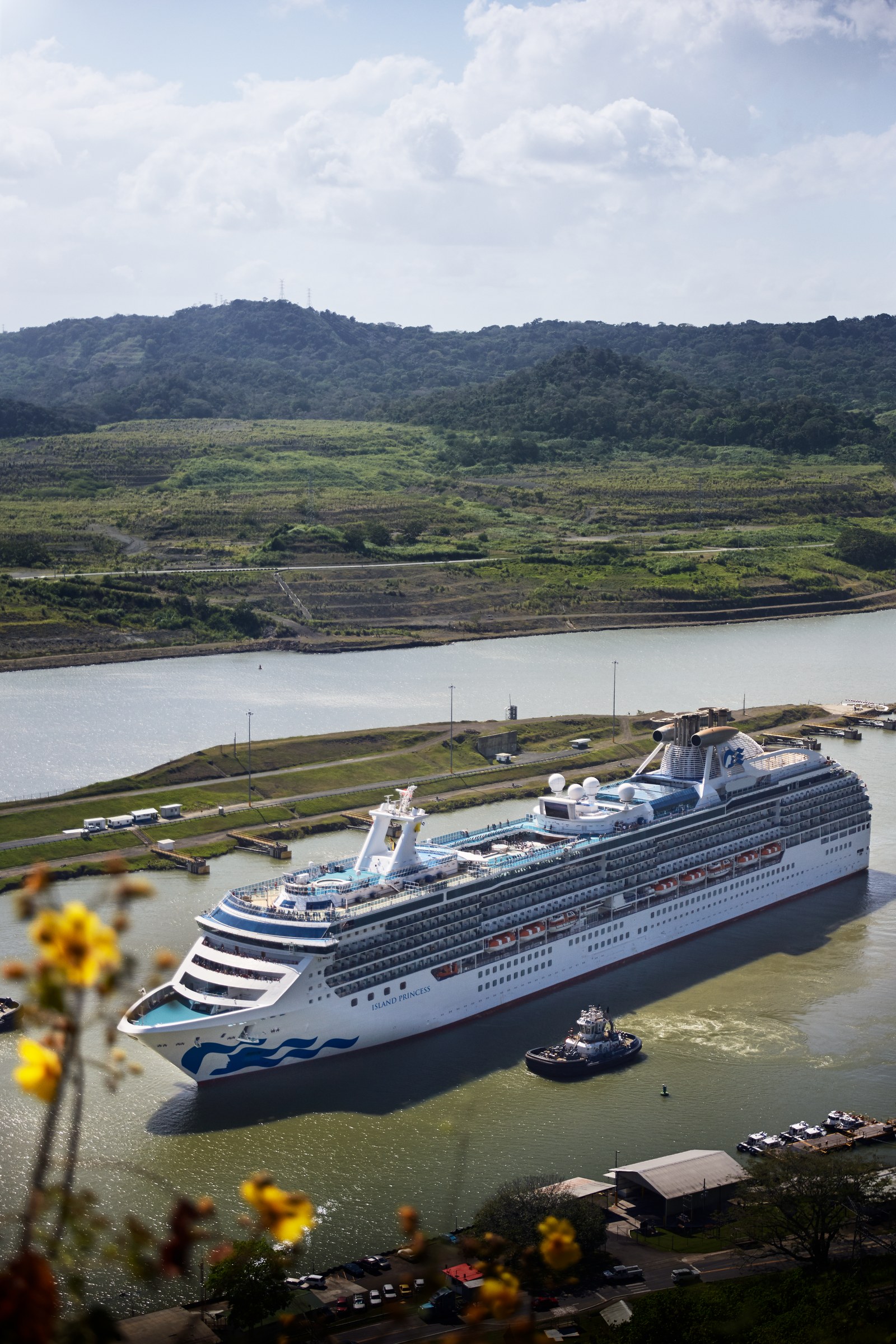 Island Princess full length in the Panama Canal under bright sun